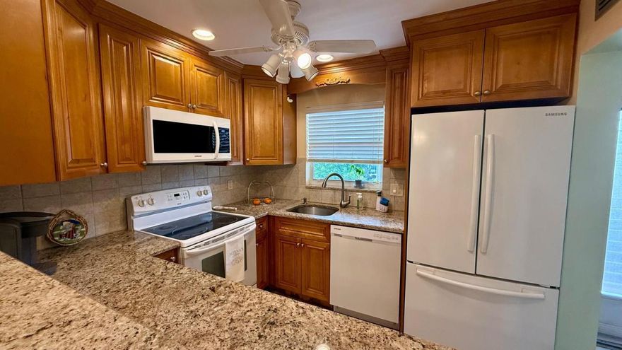 Move right in and start living your best 55+ lifestyle at Lakeside Village! This fully furnished, 1-bedroom, 1.5-bath condo is spotless, comfortable, and completely move-in ready—just bring your suitcase.

Inside, you'll love the bright, open living and dining area with neutral tile floors throughout for easy care. The enclosed Florida room with a wall of windows is the perfect bonus space for morning coffee, a reading nook, or home office—with a peaceful view over the community. The kitchen features solid wood cabinets, granite countertops, and white appliances, plus a convenient pass-through to the dining area for easy entertaining. Your large bedroom offers plenty of space for a king bed, a generous walk-in closet, and an ensuite bath. Major updates and expenses are already taken care of for you:

- Fully furnished - everything stays
- New AC for peace of mind and year-round comfort
- Roof assessment already paid in full
- Water, cable, and internet INCLUDED in the monthly fee
- Assigned parking space just for you

Living here, your world extends far beyond your front door. Lakeside Village is a vibrant 55+ community packed with amenities for an active, social lifestyle. Spend your days at the clubhouse, cool off in two sparkling pools, or meet friends for shuffleboard, bocce, or putting green practice. Join in on arts & crafts, exercise classes, line dancing, and more. There's even a bus stop conveniently located near the building, making it easy to get around without a car. On-site laundry facilities keep things simple and convenient.

Homes in this condition and price point go fast in Lakeside Village. Schedule your private showing today and make this beautifully furnished Lakeside Village condo yours before it's gone.