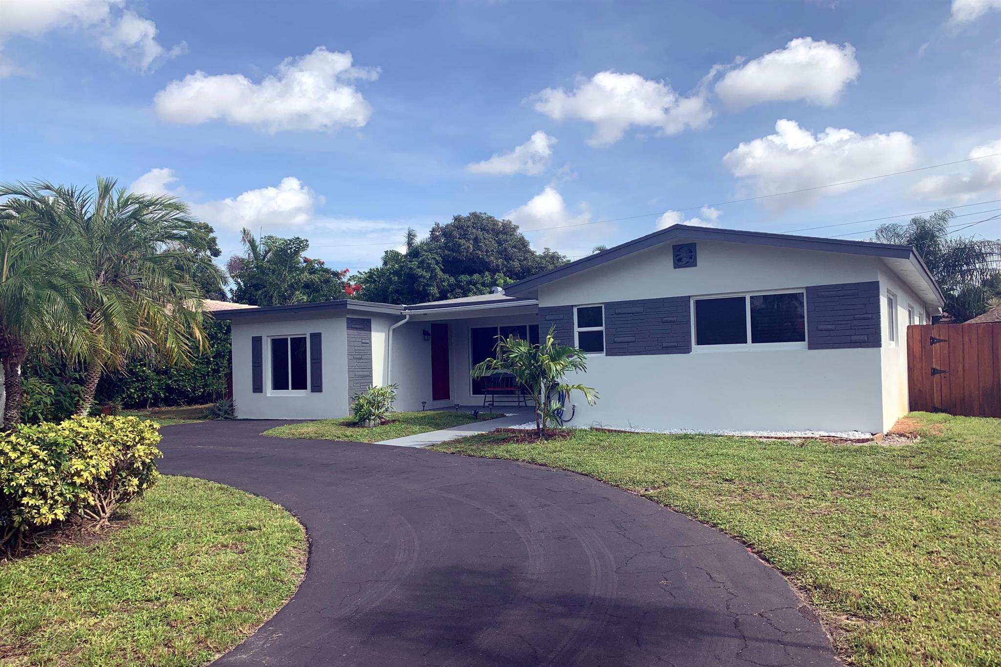Updated 3/2 in east Boca PLUS bonus room (converted garage) with closet. Almost 2000sq ft under air. Large circular driveway. Beautiful kitchen with quartz counter tops and Frigidaire stainless steel appliances. Oversized laundry room with plenty of storage space and newer washer/dryer. Porcelain tile throughout the home. The great room leads to a spacious covered / screened patio. There is a 2nd open patio offering tons of space for outdoor entertaining. The property also includes a storage shed and a tiki hut all within your private fenced backyard. Minutes to shopping, the beach and Mizner Park nightlife. This home wont last!