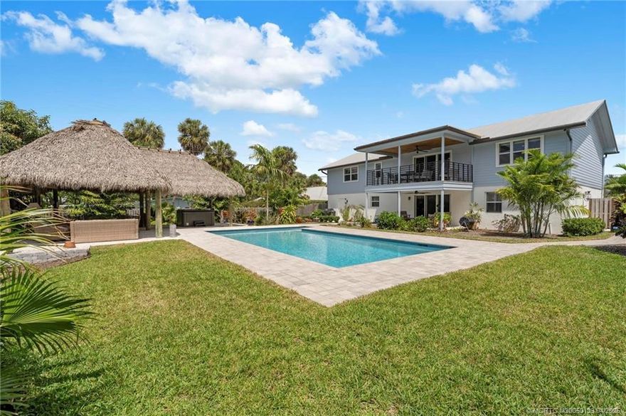 Welcome to your tropical oasis in the heart of St. Lucie Estates--one of downtown Stuart's most beloved historic neighborhoods. This beautifully renovated 5 bed, 3 bath split-level home offers plenty of space for family and guests. The lower level features a private entrance, full kitchen, 2 bedrooms, a bath, and a cozy sitting area--perfect for an in-law suite, guest quarters, or Airbnb. Step into the lush backyard paradise with a sparkling pool, oversized Tiki hut, and soothing hot tub--ideal for relaxing or entertaining after a day on the water. Stroll under the shade of mature mango and tropical trees or enjoy sunsets at the nearby waterfront park. Just a short bike or golf cart ride to downtown Stuart's shops, dining, and charm. Close to beaches, schools, and marinas.