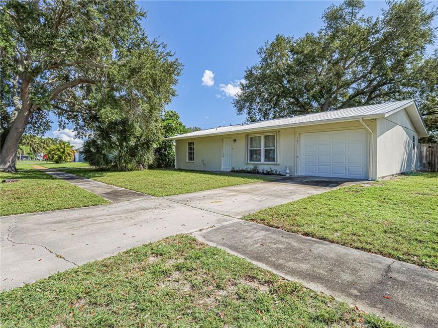 Charming concrete block home in the heart of the Vero Beach Highlands surrounded by lovely mature oak trees! Spacious space with 2 bedrooms, 2 baths + large den (with closet!). Newer kitchen has been updated with white cabinets, stainless appliances and granite counters. Laundry room is tucked away off of 1 car garage which leads out to darling fenced back yard with lots of room for your pets to play. 2019 metal roof, freshly painted exterior and cute walk-up entrance. Turn this cutie into something truly special and make this your home, or investment, today!