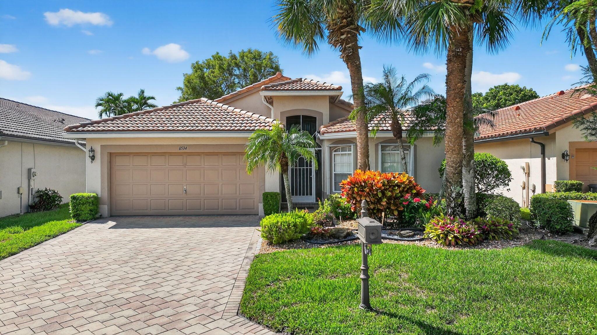 Welcome Home! This is a stunning, modified Augusta model that boasts 3 true bedrooms, 2 full updated bathrooms, NEW ROOF IN 2021 and a 26 x12 screen enclosed patio. From the moment you step into the home you are greeted with a foyer & volume ceilings which make this home spacious, bright, warm and inviting. There is neutral tile in all living areas & the 2nd bedroom and carpet in two of the bedrooms. A spacious UPDATED EAT-IN KITCHEN WITH WOOD CABINETRY & PULLOUTS, CORIAN COUNTERTOPS, FULL STONE BACKSPLASH and SS appliances. Entertaining is a pleasure as there is a great room right off of the kitchen. There is a spacious owner's suite which consists of 2 CUSTOM FITTED walk-in closets, an updated sumptuous bath with dual sinks, a large soaking tub, a step-down shower and SEE ''MORE''