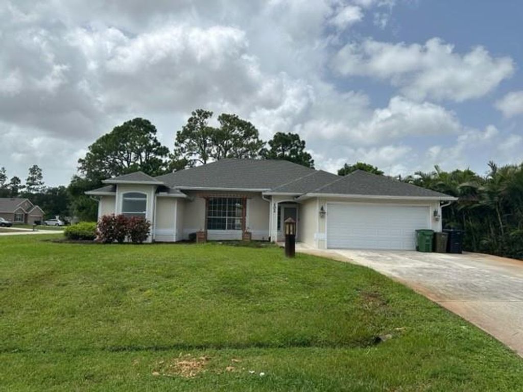 Photo of 102 NW Peach St, Port St Lucie, FL 34983 (MLS # F10396374)