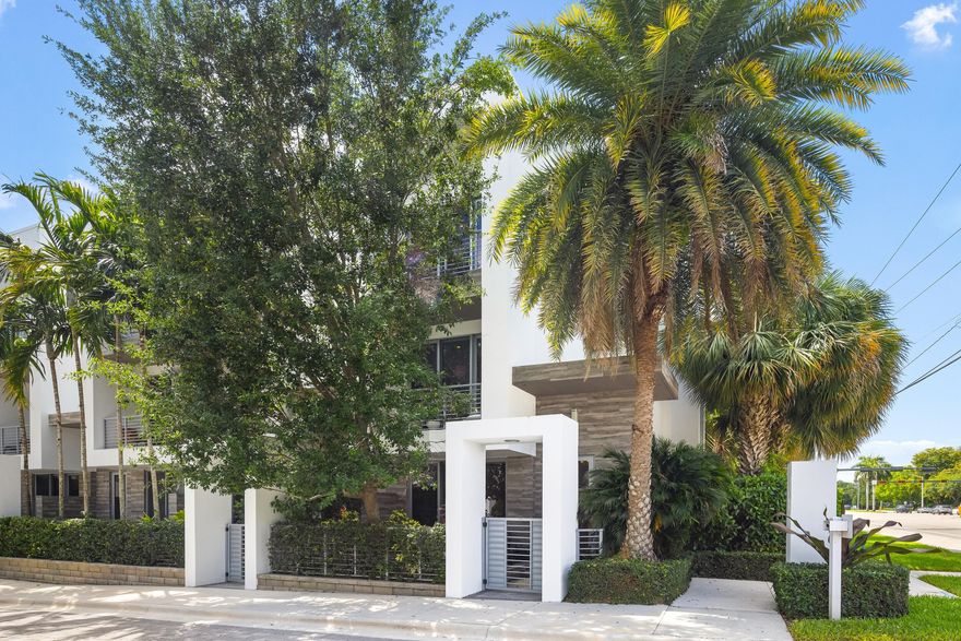 Welcome to Moderne Boca Raton, where contemporary architecture and refined living converge within an exclusive gated community in the heart of Boca Raton. Ideally situated in one of the community's most desirable locations, 1851 NW 40th Drive presents a sophisticated three-story townhome offering a seamless blend of modern design, functionality, and luxury. This thoughtfully designed residence encompasses 2,189 square feet under air and features 3 bedrooms, 3.5 bathrooms, and a private two-car garage featuring polyaspartic floor coating. Clean architectural lines, abundant natural light, and an open-concept layout create an inviting living environment well suited for both everyday living and effortless entertaining. Enhancing both comfort and convenience, the home is equipped with automatic shades throughout, allowing for effortless light control and privacy at the touch of a button.  The gourmet kitchen serves as the centerpiece of the home, appointed with sleek European-style cabinetry, quartz countertops, and a suite of premium appliances from respected brands including Jenn-Air, Grohe, and Electrolux. The adjoining living and dining areas flow seamlessly, enhancing the home's modern aesthetic and livability.  The primary suite offers a peaceful retreat with generous proportions, ample closet space, and a well-appointed bath designed with contemporary finishes and timeless appeal. Additional bedrooms provide flexibility for guests, family members, or a dedicated home office, accommodating a variety of lifestyle needs.  Further contributing to the home's comfort and wellness-focused design, the HVAC system is enhanced with ultraviolet (UV) lighting technology, designed to support improved indoor air quality and system efficiency — a valuable feature for modern living.  Residents of Moderne Boca enjoy access to resort-style amenities including a beautifully landscaped pool, fitness center, and secure gated entry, all within a professionally maintained community known for its architectural distinction and convenient location.  Ideally positioned just minutes from Boca Raton's premier destinations — including Mizner Park, Town Center at Boca Raton, Boca Center, and pristine Atlantic beaches — Moderne Boca offers a lifestyle defined by accessibility, comfort, and modern sophistication.  1851 NW 40th Drive represents an exceptional opportunity to enjoy contemporary living in one of Boca Raton's most architecturally distinctive communities.