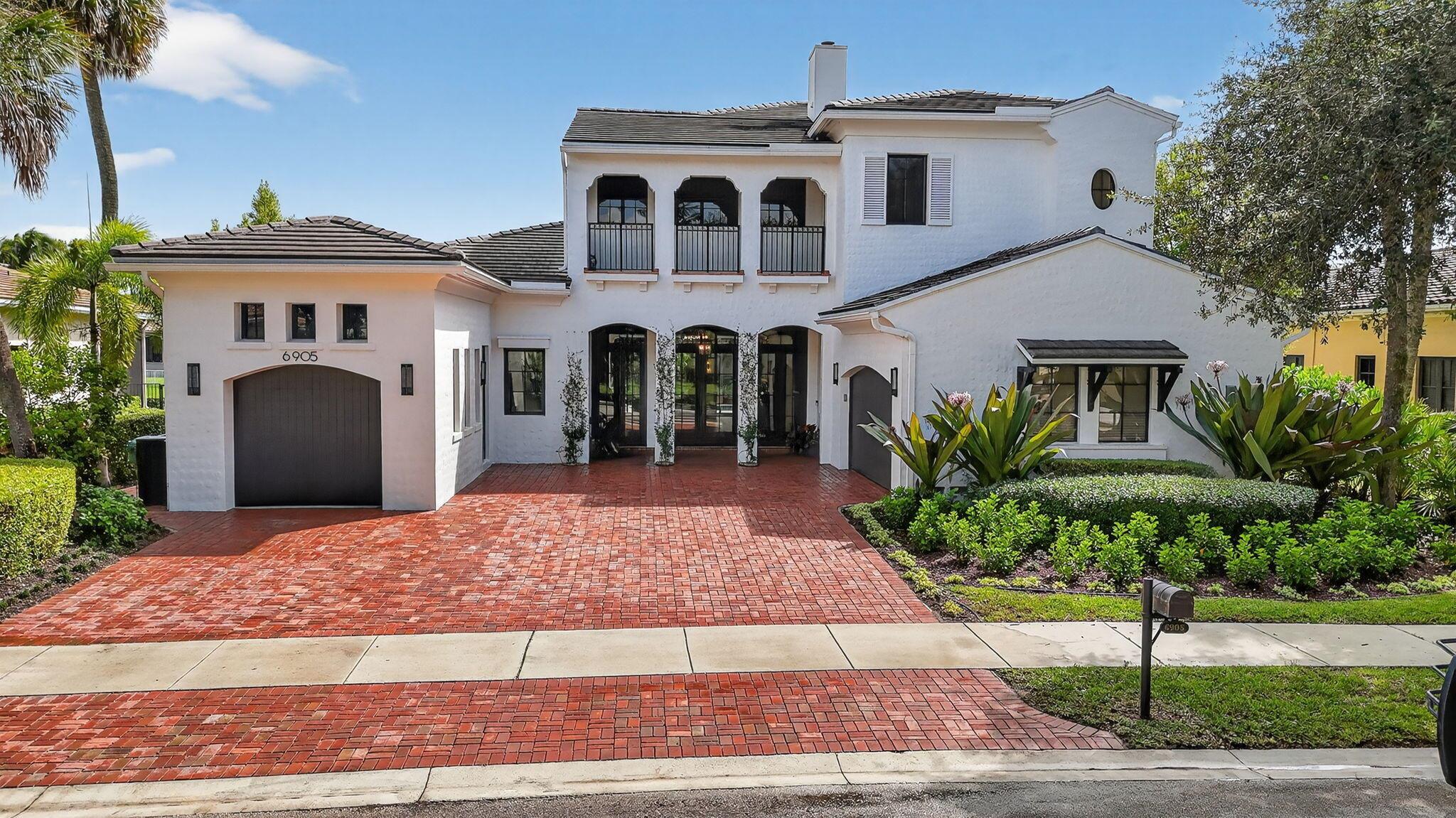 Experience refined luxury in this move-in ready waterfront estate on one of Parkland Golf & Country Club's most prestigious streets. This expanded Minorca model offers 6 bedrooms including a first-floor primary suite, 4 full & 2 half baths combining elegant design in a serene, resort-style community. Inside, in addition to the renovated kitchen, living areas & bathrooms, other upgrades include updated waterproof flooring (no carpet in sight), newly designed stairs with glass banister, and newly installed hurricane impact sliding doors for seamless indoor/outdoor living. Outside, enjoy the unobstructed view from the fully screened pool patio and lush new backyard landscaping. In addition to the private pool & spa, there is a custom outdoor grill perfect for entertaining.