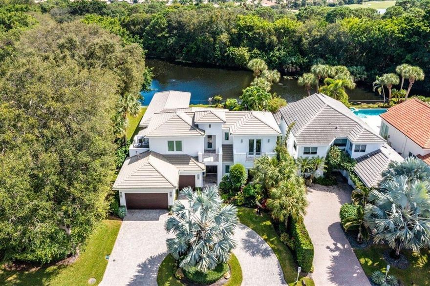 Stunning custom estate with serene lake view nestled in the exclusive Frenchmans Creek Beach and Country Club. 5 bedrooms, 4.5 baths plus office home newly built in 2014 with a contemporary design aesthetic way ahead of its time. This fabulous home shows like it was just completed. Light and bright finishes and easy living inside and out. Relaxing views of the lake and custom heated pool offer the perfect space for entertaining. The main floor luxurious primary suite offers dual custom fitted closets, french doors to the pool deck, a spa like modern bathroom with luxurious finishes & fixtures,  tub and an office / bonus room that can be accessed from the primary suite or from the main part of the house.