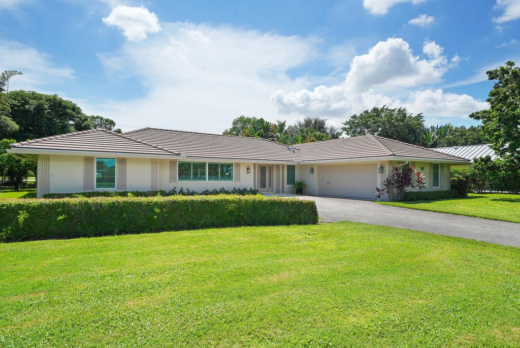 Photo of 408 S Country Club Drive, Atlantis, FL 33462 (MLS # B26077509)