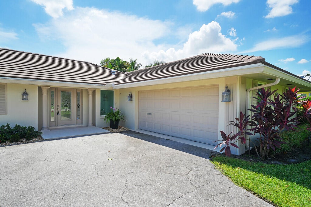 Photo of 408 S Country Club Drive, Atlantis, FL 33462 (MLS # B26077509)
