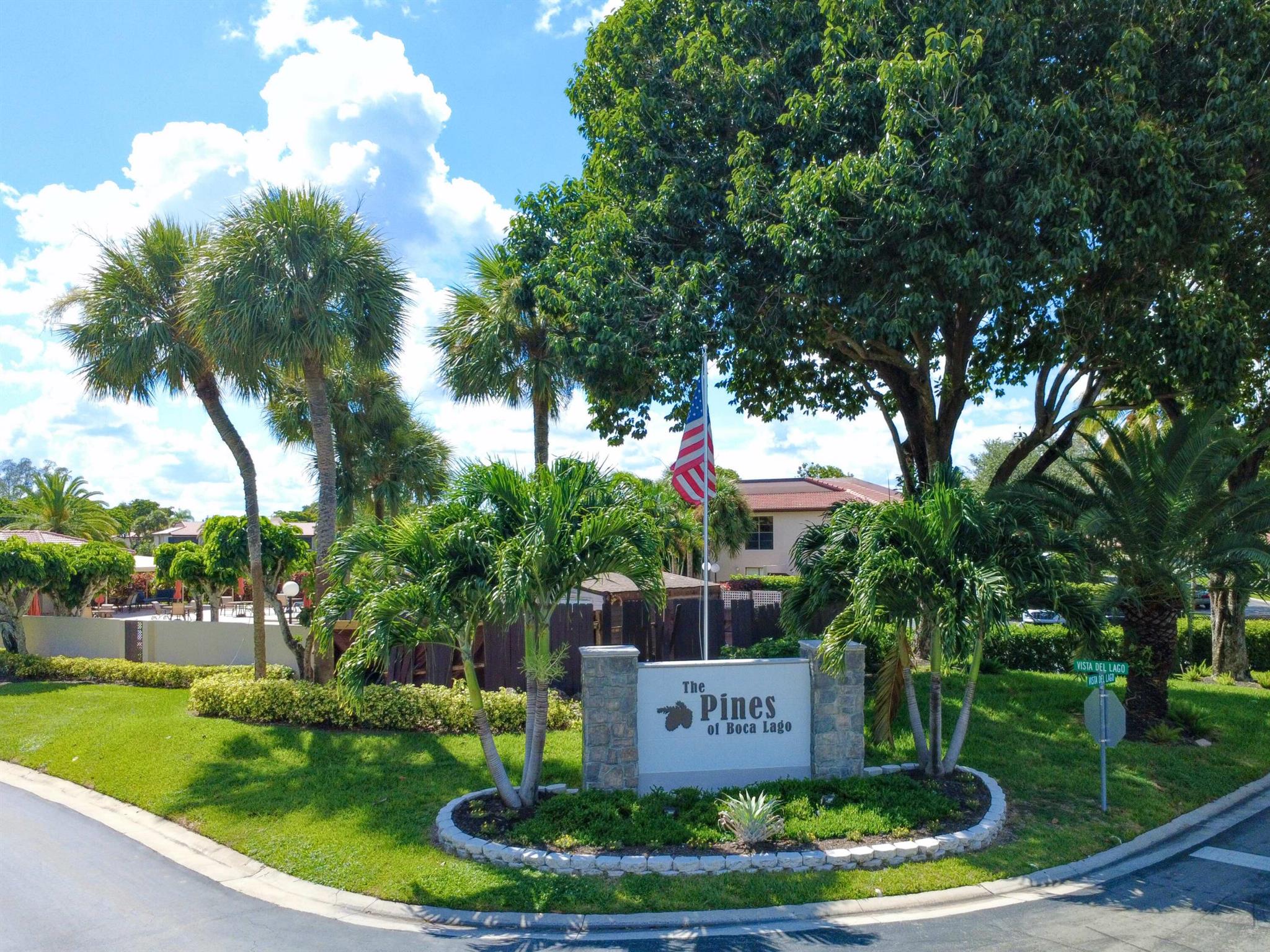 FRESH NEW LOOK with Brand New Roof installed Jan 2025! This home isn't just move-in ready, it has been thoughtfully upgraded so you can start enjoying the Florida lifestyle you've been dreaming about!Step into resort-style living in this beautifully updated 2-bedroom, 2-bath villa in the exclusive gated 55+ community of The Pines at Boca Lago. Wake up to panoramic golf course and lake views from your expansive enclosed patio -A perfect spot for morning coffee or evening wine! Inside, you'll find impact windows, plantation shutters, vaulted ceilings with recessed lighting, a custom entertainment center, tile floors throughout, and a wet bar for effortless entertaining. The popcorn ceilings are gone, the electrical details are modernized, and your private
