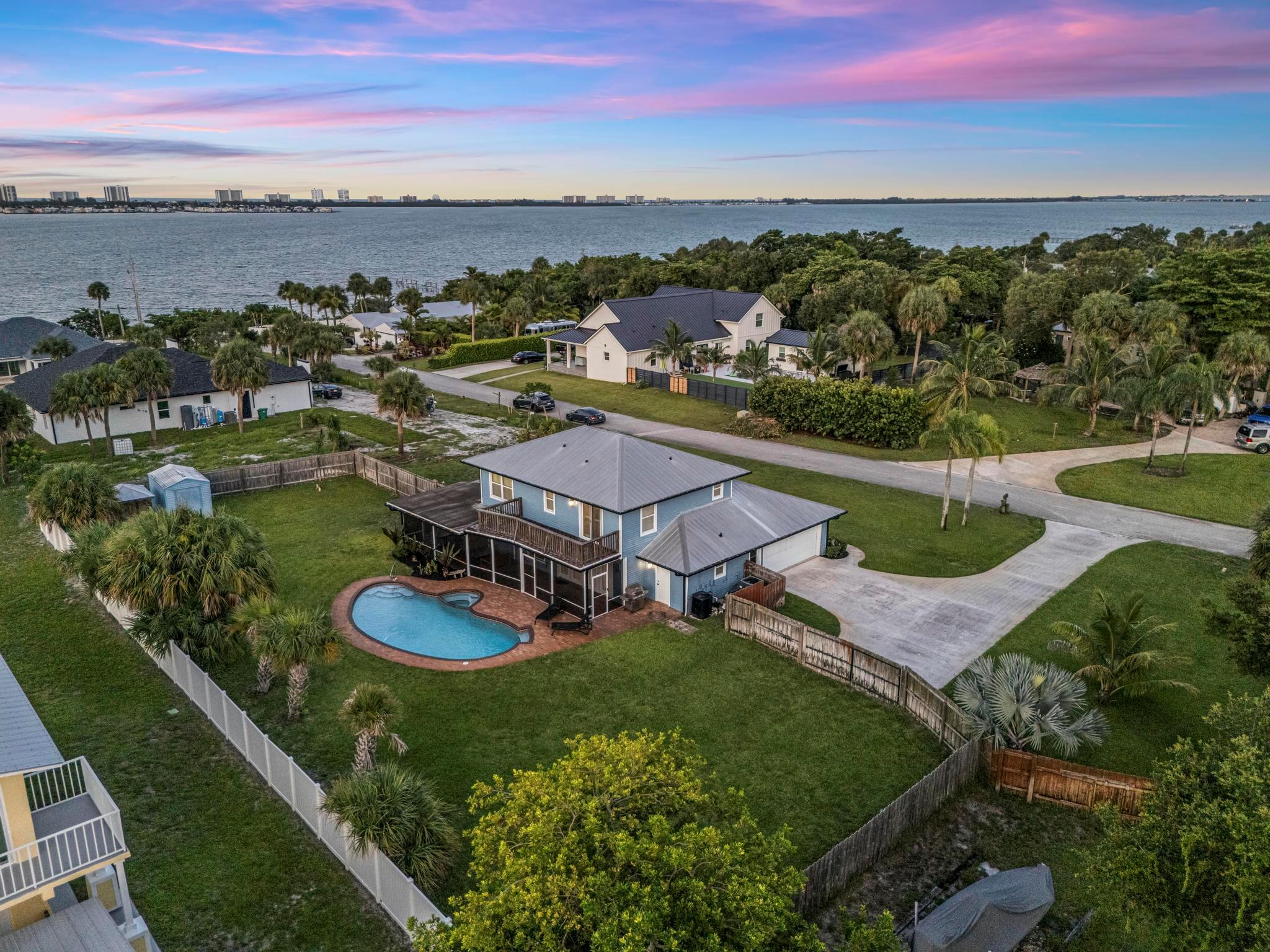 Beautifully renovated residence on a .55-acre water-view lot featuring 4 bedrooms and 3 full bathrooms (appraisal shows 3 beds, thanks to a thoughtfully converted garage bedroom that can easily revert to a 2-car garage if needed.). Upgraded in 2020 with impact-rated doors and windows, plantation shutters, recessed lighting, gutters, new A/C, irrigation with timer, grey tile and new appliances. Outdoor living shines with a refreshed pool (new piping), spa (heat pump 2018), full cabana bath, and two sheds. Major utilities include a 50-ft well (08/13/18), water softener/carbon system (06/17/19). Enjoy a new shared community dock access for boating (only a handful of homes in the HOA and potential for dock extension), without the maintenance of a private dock.