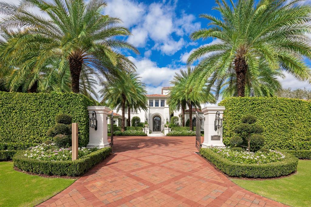 11607 Charisma Way is, without a doubt, one of the most spectacular estates in iconic Old Palm.This home is situated on a prime 1-acre lot overlooking the pinnacle of the famed and newly refreshed Raymond Floyd designed championship golf course. An acclaimed team of visionaries, including Courchene Construction, Lang Design Group, and David Gengler was assembled in 2016 to totally transform both the interior and exterior to the highest standard with no detail overlooked. At over 12,000 total square feet, this light-filled home boasts 6 bedrooms, 7 bathrooms, 2 powder rooms, a 5-car garage + additional golf cart storage. Soaring ceilings throughout measuring up to 24 feet. The chef's kitchen features custom Downsview cabinetry, a La Cornue range and a suite of high-end professional