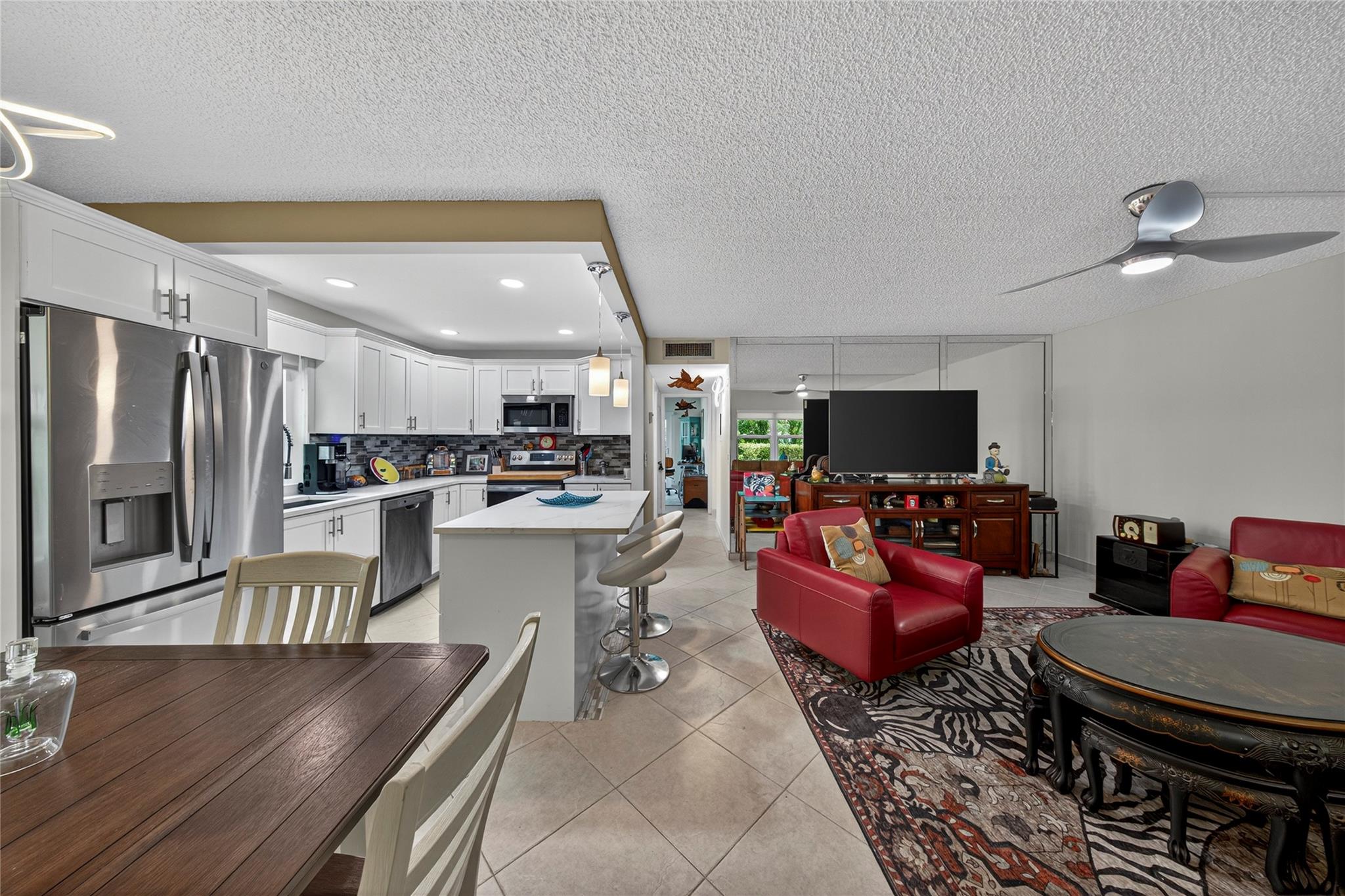 Beautifully Renovated Kings Point Condo! This light-filled residence has been fully updated and features impact windows throughout for peace of mind. Enjoy cooking in the sleek, modern kitchen and relax in the open living area designed for comfort and style. The spacious screened-in patio offers tranquil garden views, the perfect spot for morning coffee or evening unwinding. Located in the sought-after Kings Point active adult community, you’ll have access to world-class amenities including golf, pools, fitness center, theater, and more. Move-in ready and designed with today’s lifestyle in mind—don’t miss this opportunity!