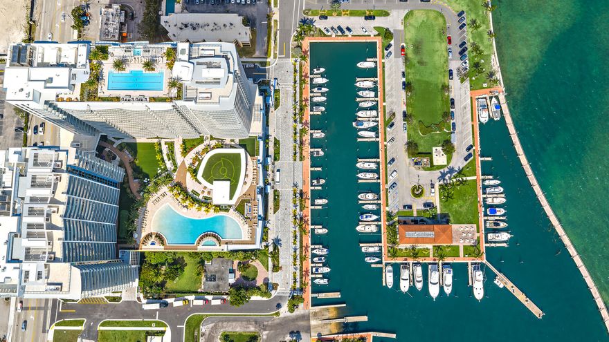 Perched on the 15th floor, this brand-new waterfront residence at Nautilus 220 delivers sweeping Atlantic, Intracoastal, and sunset views—at one of the best values currently available in the building. This 2-bedroom, 2.5-bath home features 10-foot ceilings, a clean open layout, European lighter oak flooring, custom cabinetry, quartz surfaces, and spa-style baths. The chef's kitchen is equipped with Miele appliances and a dramatic quartz waterfall island, while the North, Northeast -facing terrace captures sunrise-to-sunset views over the ICW, Singer Island AND the Atlantic ocean. The resort-style pool deck on the 6th AND top floor are AMAZING East-West exposure. Includes two garage spaces (one EV-ready) and private storage. Nautilus 220 delivers a true resort lifestyle with over 1 acre of elevated amenities, including a pool, spa, firepit lounges, and outdoor entertaining areas, plus a rooftop lap pool with panoramic water views. Residents enjoy a full fitness center, various grill stations, sauna and steam rooms, bowling alley, theater, golf simulator, concierge services, private beach access on Singer Island, and on-site waterfront dining by David Burke with some of the best steaks in Palm Beach County.