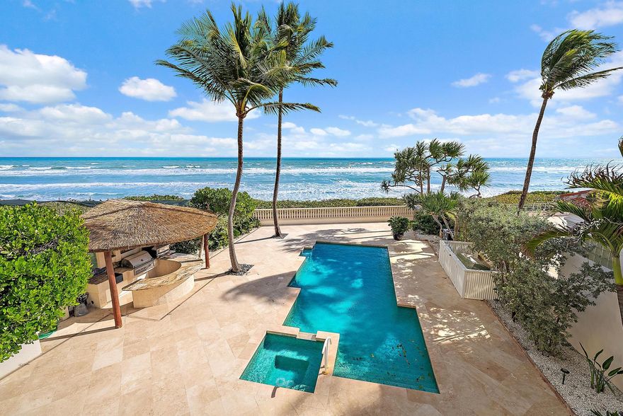 Paradise is found at Seven Hundred Ocean, an exclusive gated oceanfront community located along one of the most desirable luxury stretches of Ocean Drive in Juno Beach. Set on a rare 0.45-acre oceanfront lot, this two-story Mediterranean estate is directly on the sand, offering breathtaking sunrises, sweeping ocean views, and refreshing sea breezes.
The residence offers approximately 6,152 sq. ft. under air with 7,945 sq. ft. total building area, featuring 5 bedrooms, an office/library, 6 full baths and 1 half bath, a butler's pantry, and a private elevator. Grand interiors include a formal living room with gas fireplace and a spacious family room overlooking the Atlantic Ocean, creating seamless indoor-outdoor living. The well-appointed kitchen is designed for both everyday living and entertaining, featuring natural stone countertops and backsplash, a Sub-Zero refrigerator, Miele dishwasher, Thermador gas range, Butler's Pantry, breakfast bar seating, and a breakfast area overlooking the Atlantic Ocean and pool deck.

Ideal for entertaining, the property offers an array of indoor and outdoor living spaces, including a travertine courtyard with fountain, expansive travertine backyard deck, resort-style pool area, and a tiki hut with summer kitchen. A private gated beach entrance provides direct access to the shoreline, just steps from the home.

The second level includes the ocean-view primary suite, three additional guest bedrooms, a laundry room, and a large storage or flexible-use room. Additional highlights include a two-car garage, a roof replaced in 2022 and freshly painted interior.

Conveniently located near Pelican Lake, Jupiter Pier, Whole Foods, The Gardens Mall and major airports, this exceptional residence presents a rare opportunity to own a premier oceanfront home in one of Juno Beach's most desirable locations.