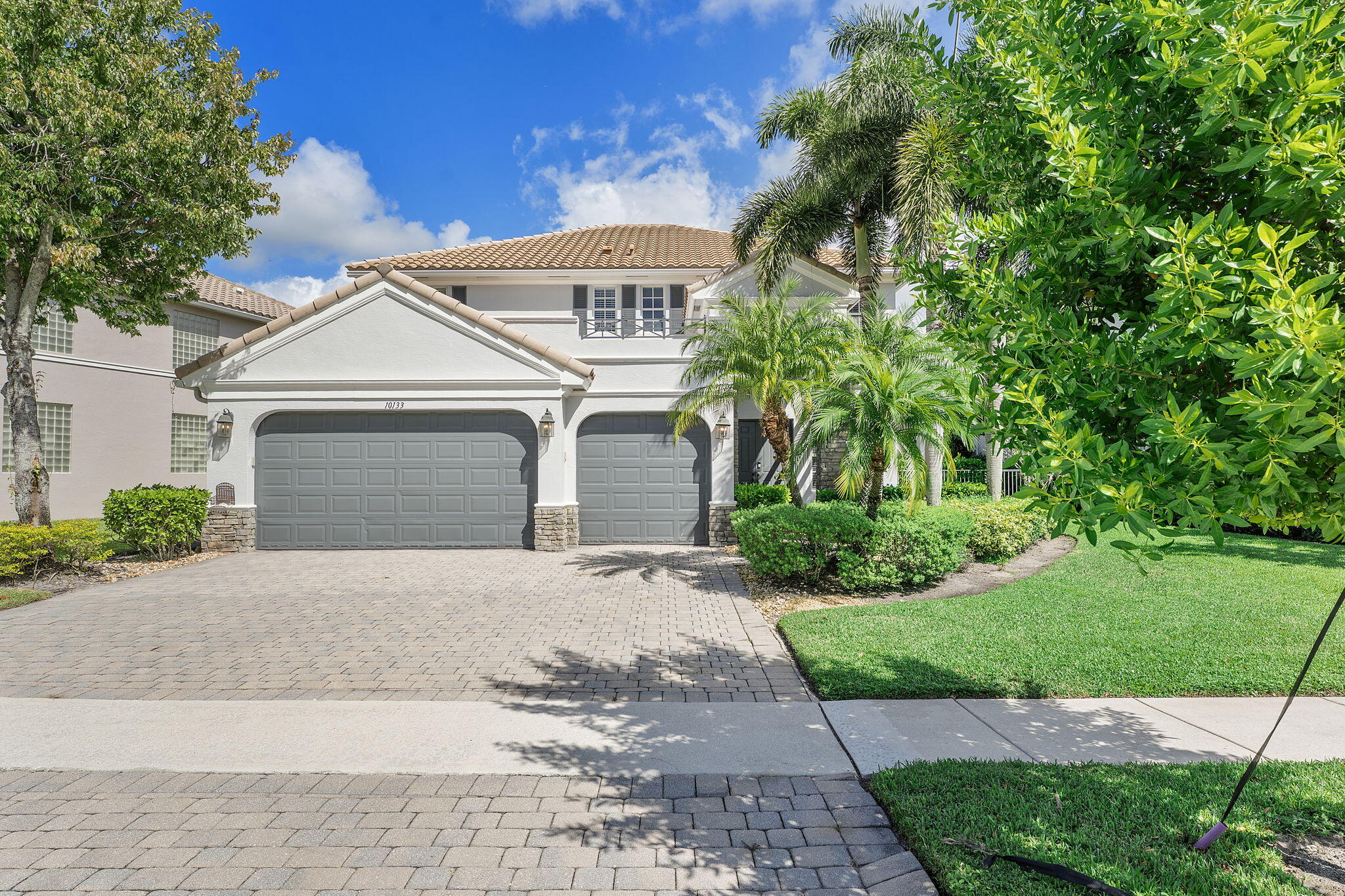 Welcome to this beautiful home featuring breathtaking lake views in a quiet, gated neighborhood. This exceptional property includes a 3-car garage and offers 2 bedrooms and 2 full bathrooms on the first floor, making it perfect for guests or multigenerational living. Step through the French doors to a covered lanai that presents stunning lake vistas, ideal for outdoor entertaining.The chef's kitchen, equipped with premium finishes and a spacious breakfast bar, is designed for gatherings of any size. Upstairs, the opulent master suite boasts a sitting area, versatile bedroom space for a home office or nursery, and two expansive walk-in closets. The updated master bath features a luxurious shower, a separate soaking tub, and dual sinks.Additional highlights include two large bedrooms,