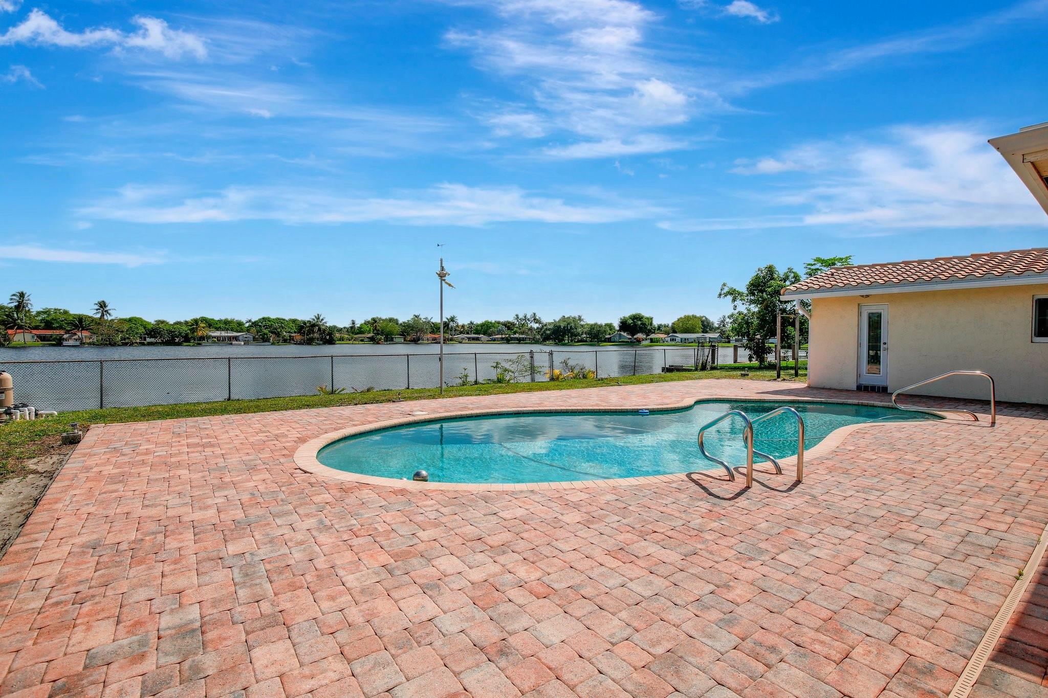 BACK ON THE MARKET! BUYER’S FINANCING FELL THROUGH — THEIR LOSS IS YOUR OPPORTUNITY! WELCOME TO YOUR PRIVATE LAKEFRONT RETREAT IN THE HIGHLY DESIRABLE ROYAL PALM SOUTH COMMUNITY, WITH NO HOA! THIS IMMACULATE 4-BED, 2-BATH POOL HOME OFFERS SERENE WATER VIEWS, A SCREENED PATIO PERFECT FOR ENTERTAINING, AND HURRICANE-IMPACT WINDOWS THROUGHOUT. ENJOY AN OVERSIZED PRIMARY SUITE WITH WALK-IN CLOSET, A BRIGHT OPEN-CONCEPT KITCHEN, FORMAL LIVING & DINING ROOMS, AND A COZY FAMILY ROOM. BONUS: RARE CONCRETE SLAB FOR BOAT OR RV STORAGE + HOME WARRANTY INCLUDED! LOCATED MINUTES FROM TOP-RATED SCHOOLS, I-595, SHOPPING, AND DINING. A TRUE WATERFRONT GEM, DON’T MISS THIS CHANCE!