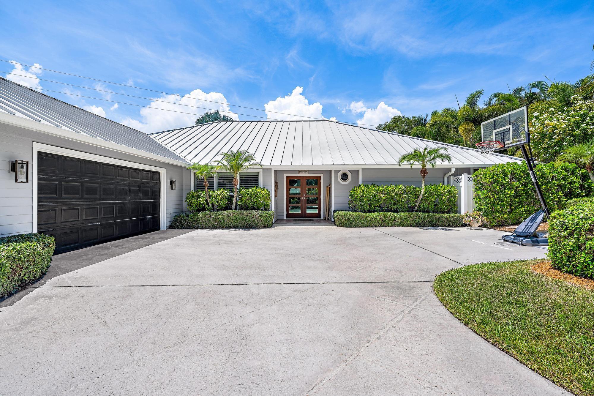 Welcome to your dream oasis in Frenchmen’s Cove. This 3,507 sq ft residence blends luxury and comfort on a private, tree-lined lot. Featuring 4 spacious bedrooms, 3.5 baths, an updated chef’s kitchen with a Sub-Zero refrigerator, and an office off the primary suite plus an upstairs bonus room, it offers versatile living. A metal roof and impact windows ensure beauty and durability. Outdoors, enjoy the sparkling saltwater pool, pergola, and lush surroundings—perfect for relaxing or entertaining. Experience this exceptional home where sophistication meets warmth.
