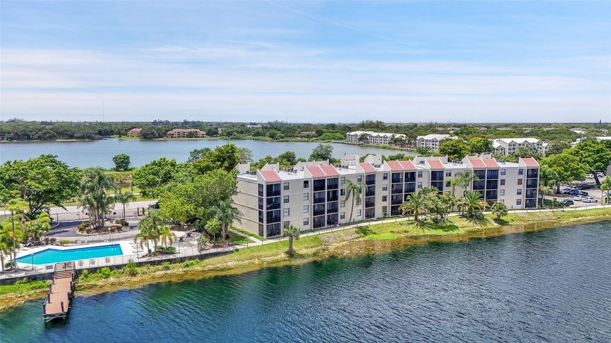 Come see this 2/2 partially furnished PENTHOUSE with picturesque lake views, situated in a secure, guard-gated community. This beautifully updated unit features a modern kitchen with white shaker cabinets, quartz countertops, and stainless steel appliances. Enjoy the convenience of an in-unit washer and dryer, and peace of mind with impact windows and brand new AC installed in 2024. The condo has been recently upgraded with new vinyl flooring and a fresh coat of paint, creating a bright and inviting atmosphere. 40 year inspection included a new roof in 2024, concrete restoration, stucco removal and replacement, repairing balconies, waterproofing and painting the building.