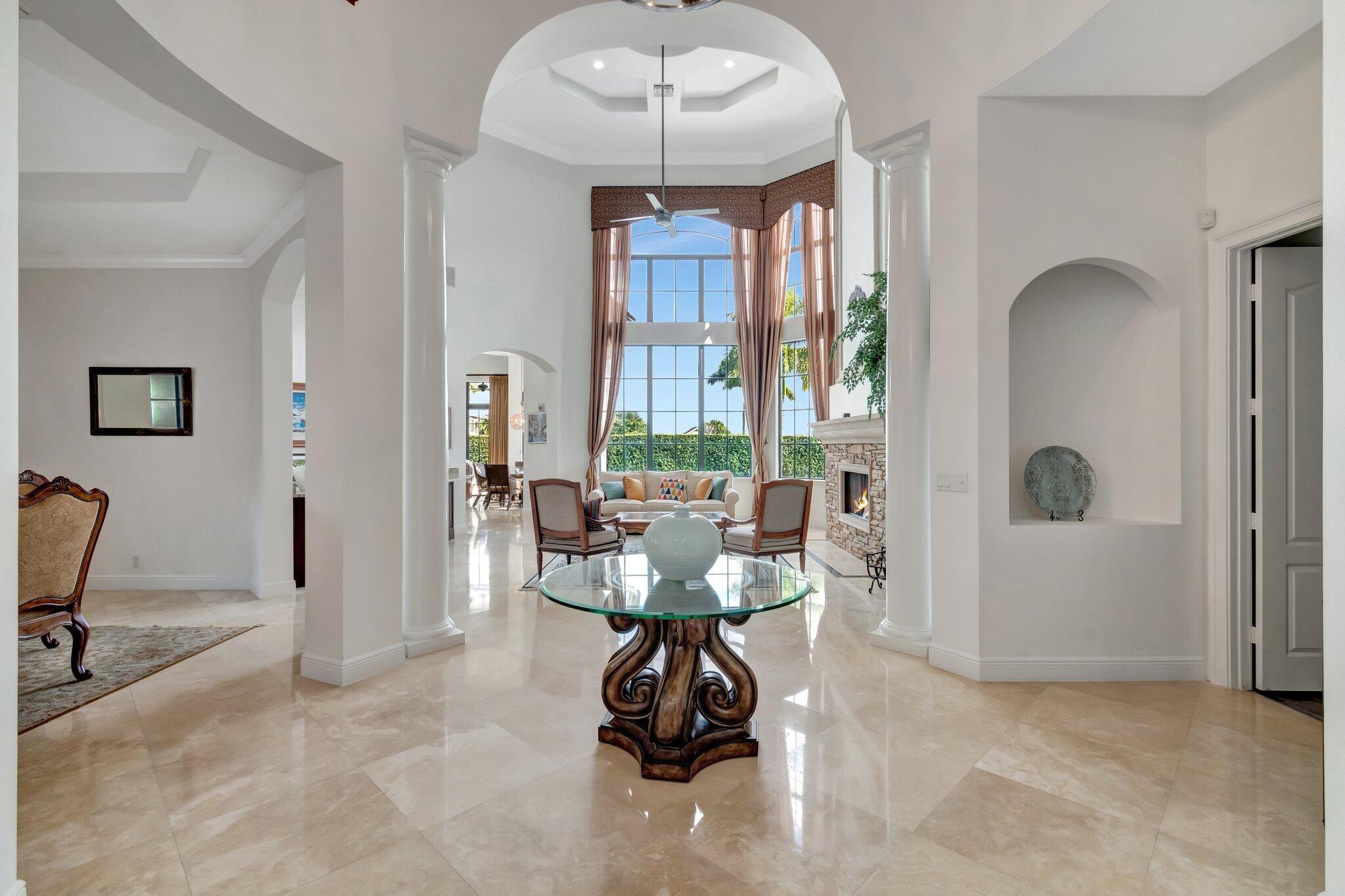 Welcome to Equus - This 5-bedroom estate is an entertainers dream built by Landmark Custom builders. You will be captivated by the soaring ceilings, elegant marble floors and serene views of the private backyard oasis. Enjoy your primary suite downstairs with an additional guest quarter on the opposite side of the home. There are 3 full ensuite bedrooms and a loft upstairs with room for everyone. The chef's kitchen is a culinary dream equipped with a gas stove, double ovens and premium stainless-steel appliances all overlooking the family room for seamless living and entertaining. The formal living area has a welcoming gas fireplace and custom bar area, perfect for gatherings. This home is equipped with full hurricane impact windows for your peace of mind.