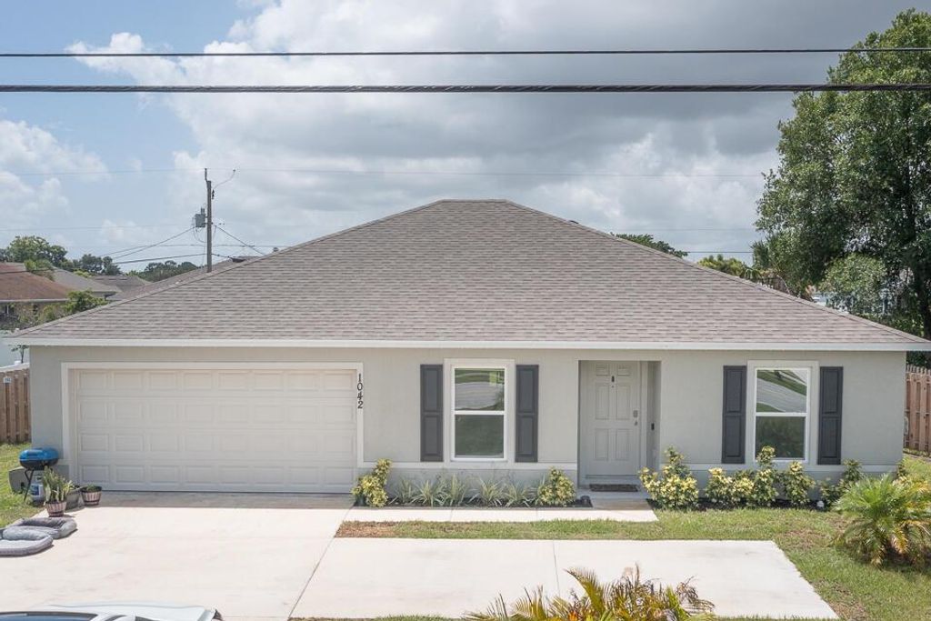 Photo of 1042 SW California Boulevard, Port Saint Lucie, FL 34953 (MLS # R11098979)