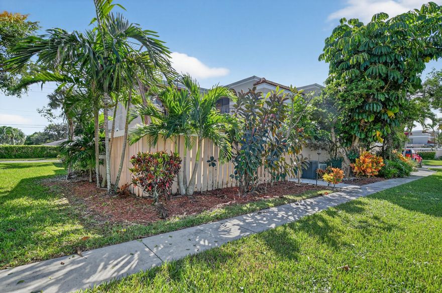 Renovated 3 bedroom, 3 bath townhouse in the heart of Delray. Fenced in private courtyard is perfect for entertaining, gardening, pets/kids to play in your own private area complete w/new storage shed. Modern dark laminate flooring on first floor and stairs, mounted cabinet in dining room for storage/serving, new doors/casing, baseboards, lighting, fans, bathrooms feature new vanities and toilets. All appliances are upgraded-refrigerator, range, dishwasher, microwave, washer, dryer. One bedroom and full bath down, upstairs are two more bedrooms w/en suite bathrooms. Home comes with two reserved parking spots, is pet friendly.  Community has two pools, tennis courts, lots of open space and shady trees to enjoy.