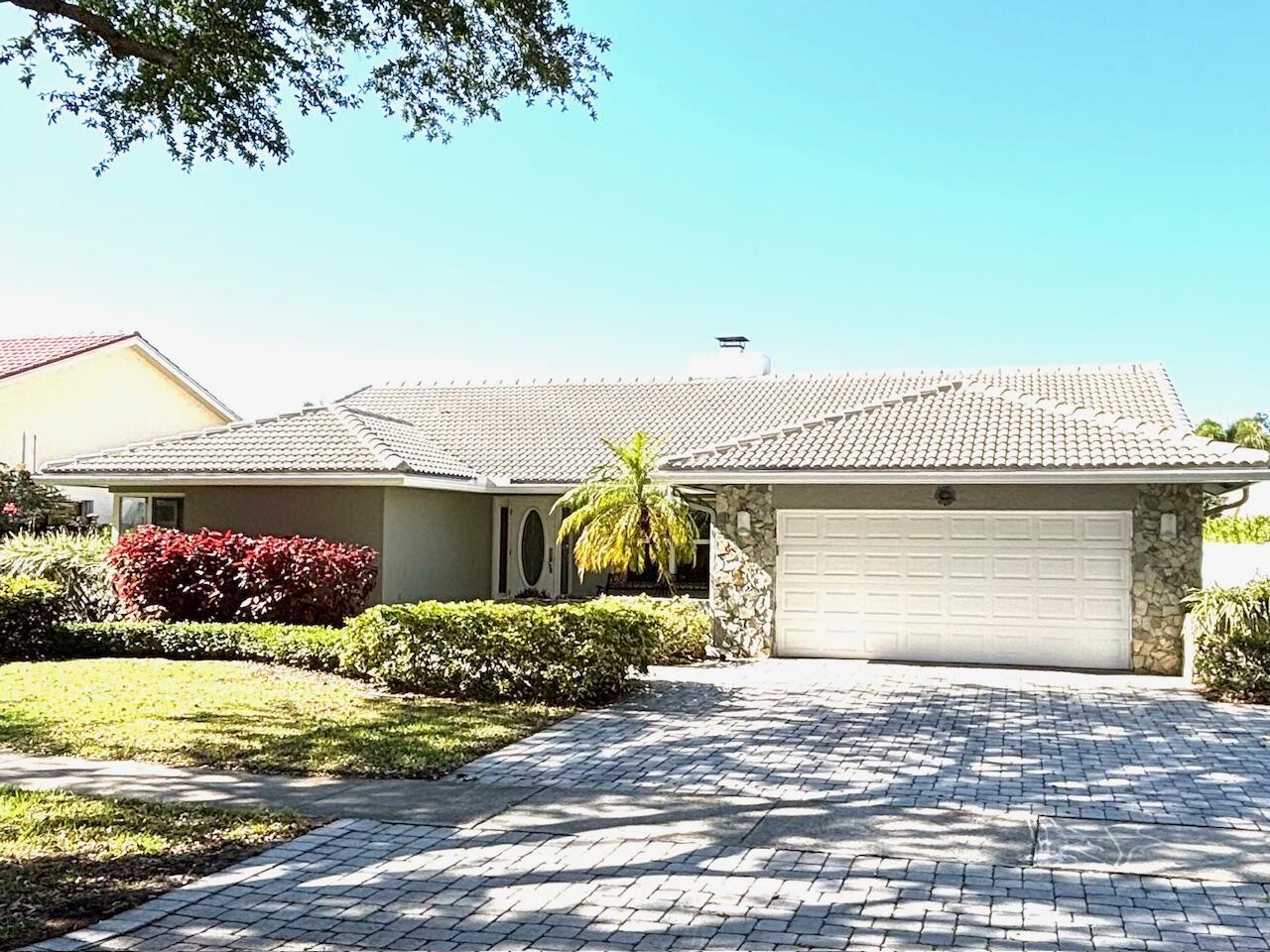 This lovely one-story home on a private lot offers 4 bedrooms & 2 1/2 baths nicely remodeled and easy to just move right into furnished or unfurnished. Features include porcelain tile & luxury vinyl flooring;vaulted ceilings;a charming sunken Living Room with twin-sided fireplace to the Family Room with stone to the ceiling;an island kitchen with white cabinetry; granite counters with a waterfall edge on the island, stainless steel appliances and extra high-hat lighting. All bedrooms have custom-configured closets. The primary, secondary and powder bathrooms have been remodeled as well. Hurricane protection includes impact windows & doors and accordion shutters. The outdoor space offers silver travertine pavers, a covered lanai with summer kitchen, screen patio with a pool & grassy area.