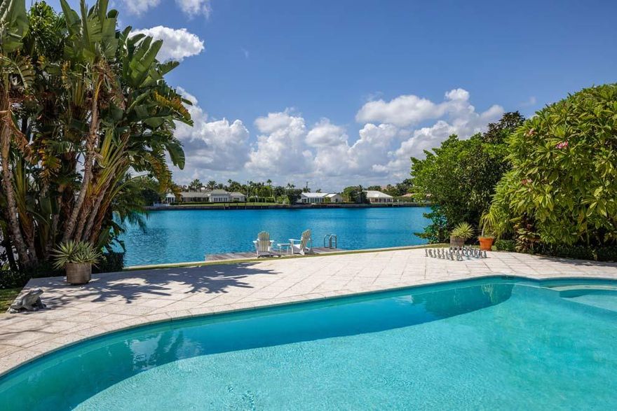 This Point Manalapan home offers 96 feet of waterfrontage with views of Manatee Cove. Boasting 4,192 total square feet, the residence offers endless possibilities. Move in and personalize or build your dream home on over one-third of an acre with 150 feet of depth. The residence features open living spaces; kitchen with island, snack bar seating, and breakfast area; club room; separate office; primary bedroom with bath and walk-in closet; and two additional en suite bedrooms. Outdoor living is easy with large covered loggia; heated pool; spa; and dock with easy access to the Intracoastal and ocean. Residents of Point Manalapan enjoy gratis membership to the La Coquille Club at the Eau Palm Beach Resort & Spa. Situated between Delray Beach and Palm Beach, FEATURES
" Located on Manatee Cove in the private community of Point Manalapan
" 96 feet of waterfrontage with dock 
" 3 bedrooms / 3 baths
" 2,913 square feet under air / 4,192 total square feet
" Tropical landscape with impressive Autograph Tree (Clusia Rosea) enhanced by decorative circular drive
" Portico and double glass doors with foyer entryway
" Living room has bar and fabulous views of the pool and Manatee Cove with access to covered loggia through two sets of glass French doors
" Dining area is open to the living room and conveniently located next to the kitchen
" Kitchen offers island with snack bar seating; Thermador gas range; Sub Zero refrigerator; warming drawer and breakfast area
" Club room is open to kitchen and has access to the garage
" Separate den or office just off breakfast area
" Primary bedroom has bath with shower and tub; walk-in closet; and French doors to covered loggia, pool and backyard
" Two additional en suite bedrooms
" Expansive covered loggia with retractable awning; hurricane screens; and lots of room for outdoor living and dining
" Large open patio for lounging poolside
" Heated pool and spa
" Dock with nearby access to Intracoastal Waterway and ocean via nearby inlet
" Laundry room off kitchen
" Two car garage with 220 plug for electric car
" Full-house generator
" Two air-conditioning zones
" Electric blinds
" Wired for speakers and music throughout
" Impact glass 
" Two water heaters (one gas and one electric)
" Private community with Manalapan security patrol
" Dedicated Town Hall; Library and Police
" Gratis membership to the La Coquille Club at the Eau Palm Beach Resort & Spa

This Point Manalapan waterfront property offers a great opportunity.