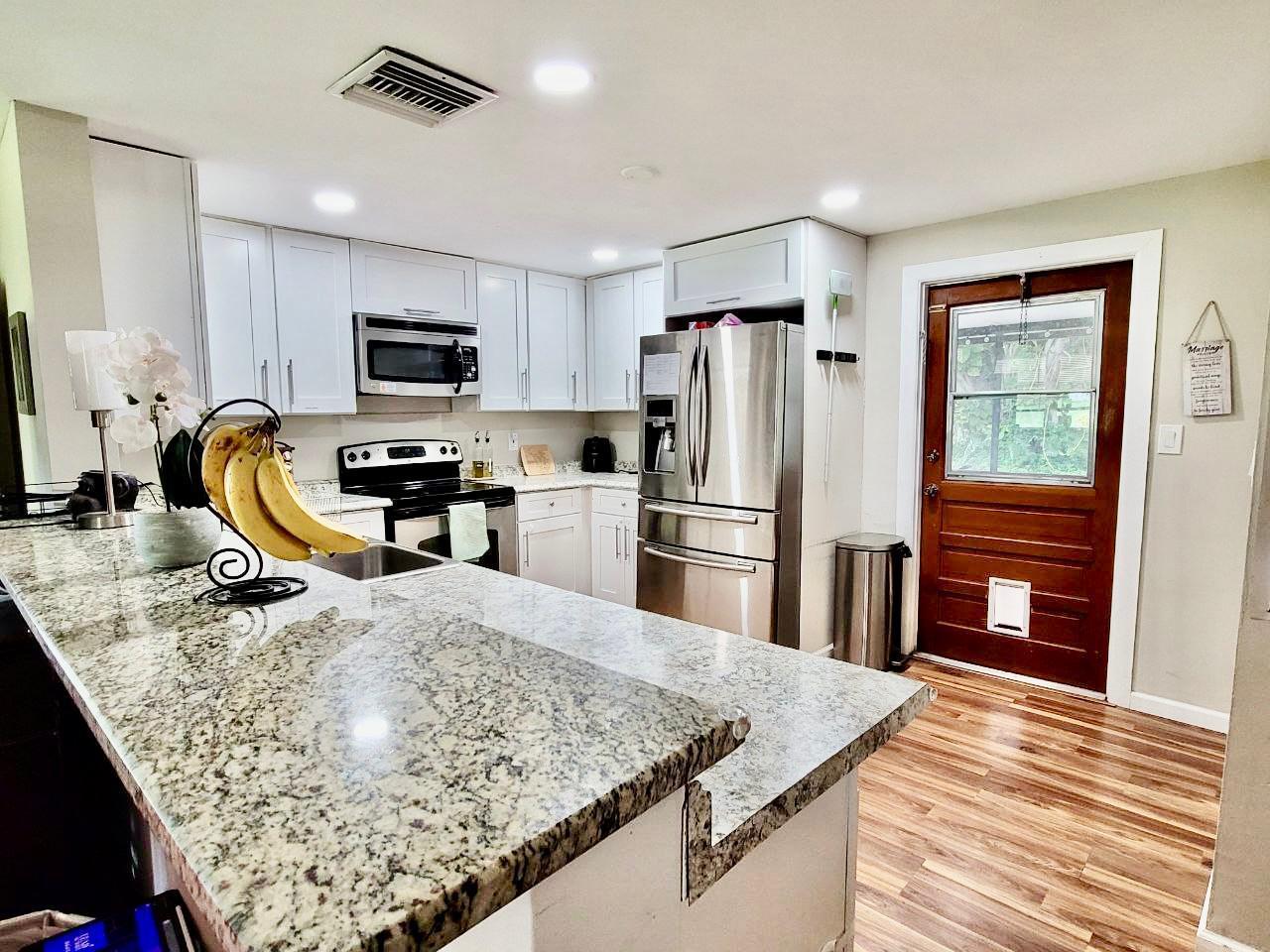 Available for short-term rental starting September 28th--don't miss out on this charming gem! Discover this enchanting, revitalized cottage that perfectly blends character with modern amenities. Boasting a large yard ideal for entertainment or parties and shaded by lush trees, this cozy home offers an inviting layout filled with natural light. Enjoy resilient flooring throughout and a contemporary kitchen stocked with essentials. Fully furnished with a king bed, queen bed, and optional baby crib, this home is move-in ready. Internet is included in the rent for added convenience. Located near Boynton Beach Mall, grocery stores, and parks like Galaxy and Wilson, and just an 8-minute drive to the beach, it's ideally situated for easy access to shopping, dining, and outdoor activities