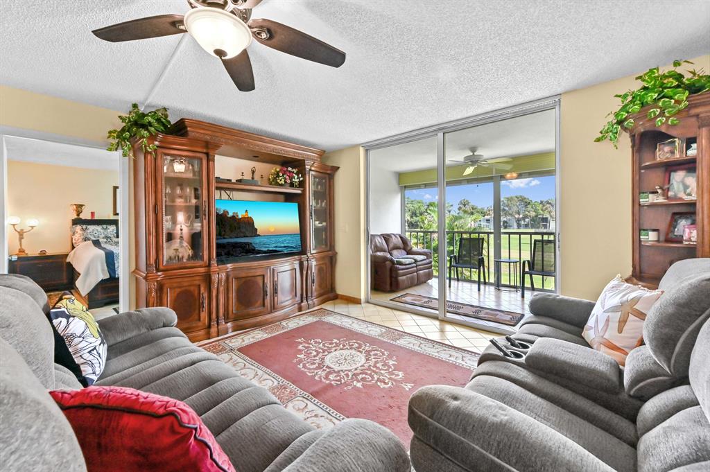 Discover this bright and beautifully maintained 2-bedroom, 2-bath waterfront condo in the sought-after community of Palm Springs 2 in Margate. Enjoy peaceful golf course and canal views from your private, screened balcony--perfect for morning coffee or evening relaxation.This spacious second-floor residence offers an inviting layout with tile flooring throughout, a split-bedroom plan, and a comfortable dining-living combination ideal for entertaining. The primary suite features a walk-in closet and a private bath with a separate shower. The updated kitchen includes an eat-in area and all major appliances, including a washer and dryer, conveniently located inside the unit.  Minimum credit and income requirements.