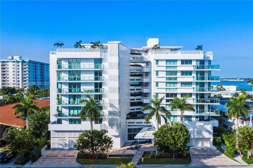Situated within the distinguished community of Bay Harbor Islands, this impeccably designed two-bedroom, two-bathroom residence offers an exceptional living experience, combining contemporary elegance with practical functionality. Abundant natural light fills the space, highlighting a thoughtfully designed split floor plan. The gourmet kitchen is outfitted with premium, top-of-the-line appliances, including an under-counter wine cooler, catering to both culinary enthusiasts and entertainers alike. The expansive primary suite features a luxurious en-suite bathroom and generous walk-in closets.