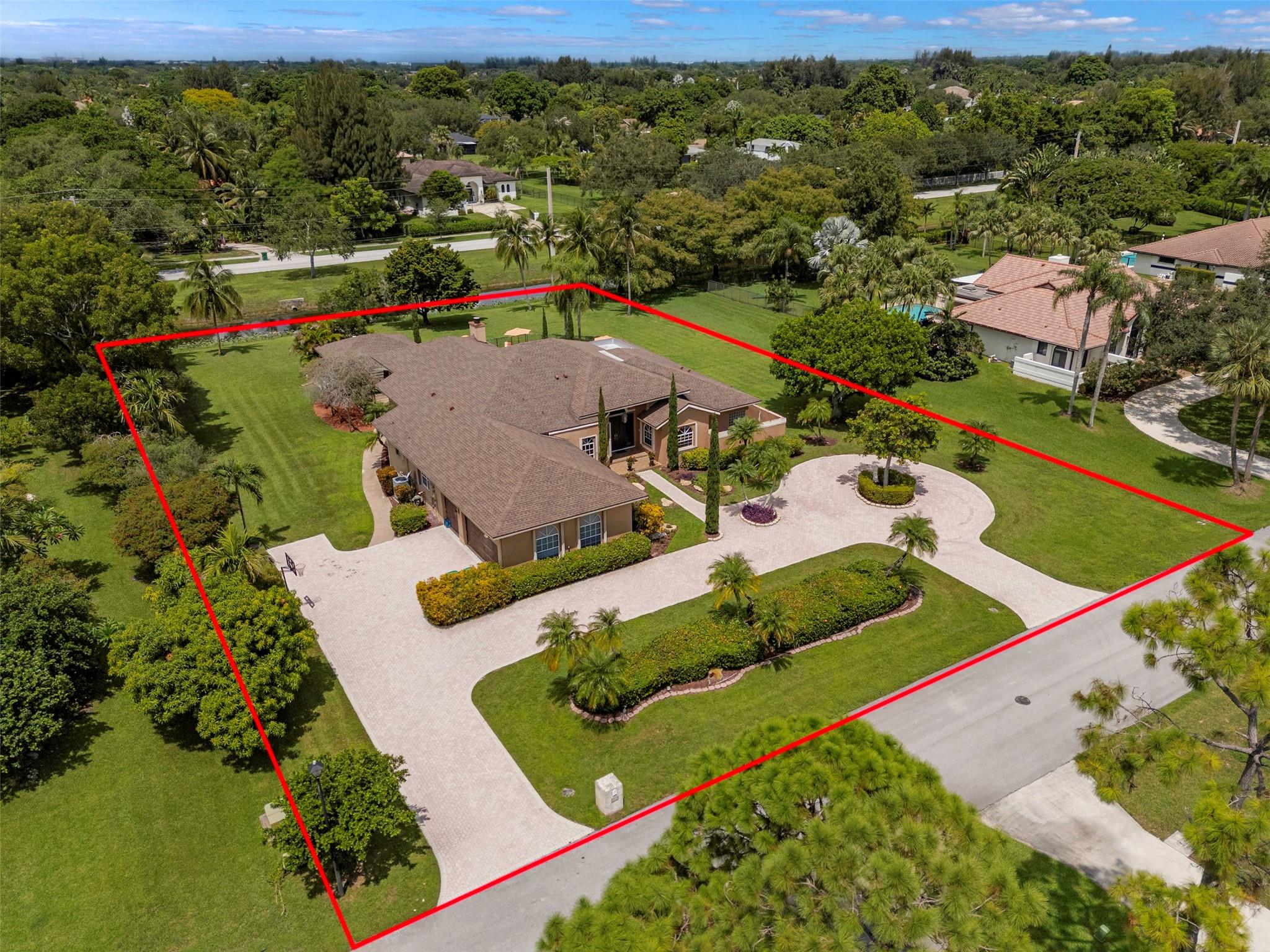 THIS IS A RARE OPPORTUNITY TO OWN A RESORT STYLE HOME DESIGNED FOR COMFORT AND ENTERTAINING LOCATED IN THE HEART OF DAVIE IN THE HIGHLY DESIRABLE WHISPERING PINES COMMUNITY. 4 BEDROOM 3 1/2 BATH POOL HOME ON A BUILDERS ACRE. THIS 4,435 SF HOME FEATURES SPLIT BEDROOMS, JACK AND JILL BATH, GOURMET KITCHEN, SUNKEN LIVING ROOM, FIREPLACE, WET BAR, FORMAL DINING ROOM, SEPARATE BREAKFAST AREA DINING, HUGE MASTER BEDROOM WITH SITTING AREA, LAUNDRY ROOM, OUTDOOR TIKI BAR WITH FULL KITCHEN, 250 GALLON UNDERGROUND PROPANE TANK, A 3-CAR GARAGE, AND TOO MUCH MORE TO MENTION. CLOSE TO I-75, I-595, FLORIDA TURNPIKE, SHOPPING, AND AMERICAN HERITAGE SCHOOL. THIS IS WITHOUT A DOUBT AN INCREDIBLE FIND.