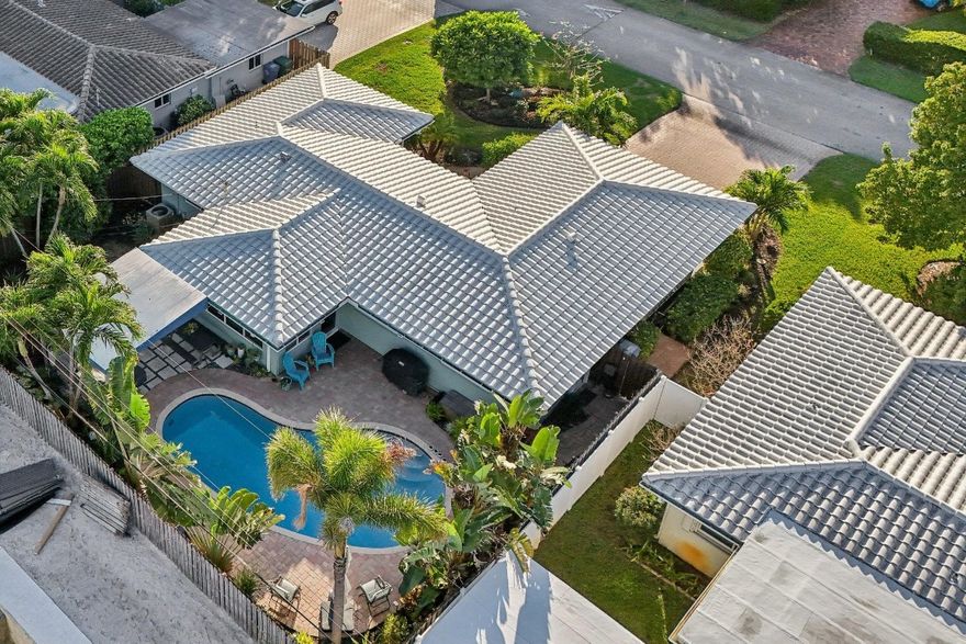 Located in the desirable Coral Woods neighborhood of Oakland Park, this inviting pool home offers relaxed South Florida living. The updated kitchen features quartz countertops, while a light-filled Florida room—currently used as a dining space—adds flexibility for everyday living and entertaining. Wood floors bring warmth throughout, and updated bathrooms provide added comfort. Step outside to enjoy a private pool perfect for weekends at home. The property also includes a power outlet for electric vehicle charging. Conveniently located minutes from the beach, Wilton Manors, and downtown Fort Lauderdale.