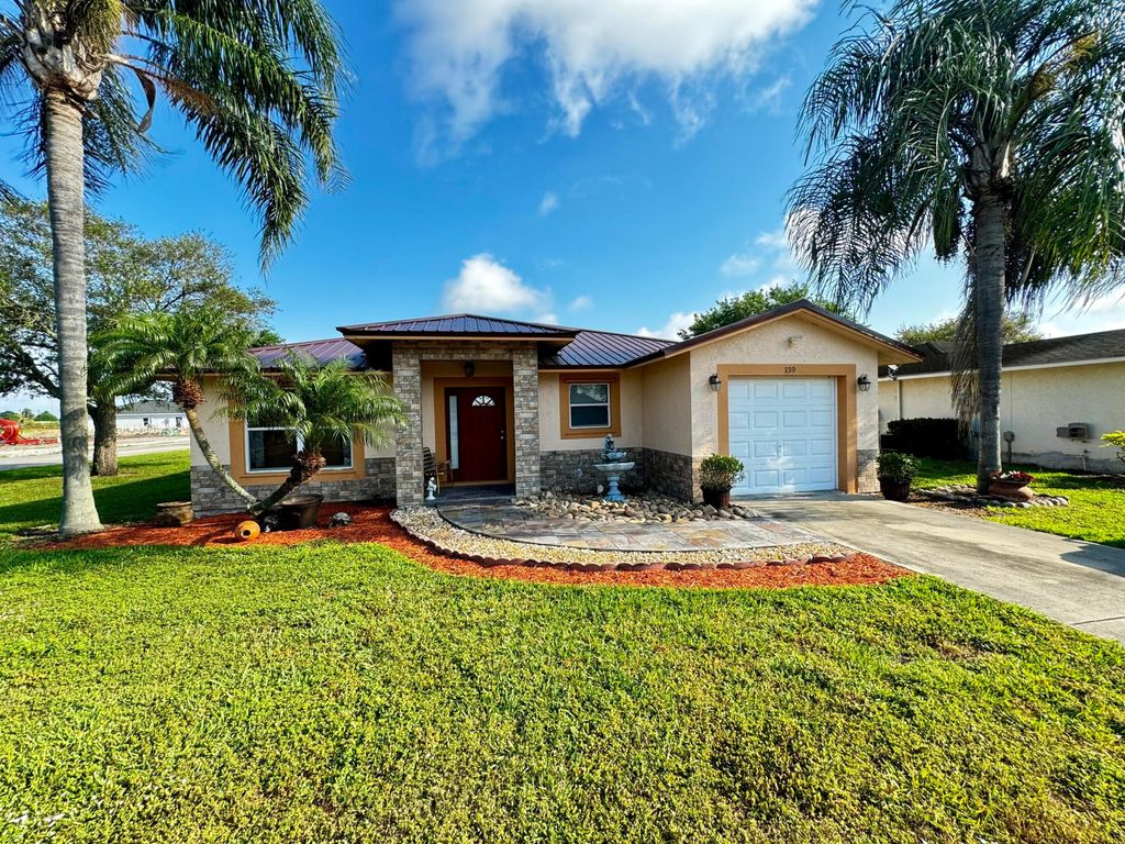 Photo of 139 Dabou Loop, Belle Glade, FL 33430 (MLS # R10969863)