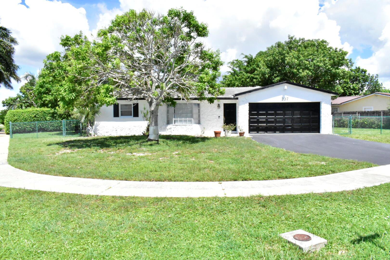 Charming well maintained single family 4 bedrooms 2 baths home on corner lot! Open patio with privacy fence! Conveniently located near entertainment, great dining, shopping and Palm Beach Outlet mall! Also Easy access to Major Highway! NoHOA! I repeat, No HOA! Don't take my word for it, come check it out yourself!