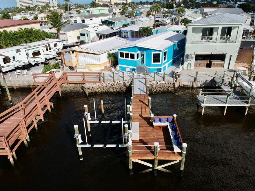 Enjoy beautiful sunsets & wide water views of the intracoastal waterway with this one of a kind property. New 52' dock (the longest in the community) with 12K boat lift. This deep water dock also has water, electric, & plenty of bench seating. Property offers 1 bedroom, 1.5 bathrooms, new impact windows & door, new kitchen with granite counters & white shaker cabinets, new vinyl flooring, vaulted ceilings, washer & dryer, and completely renovated bathrooms. Additional outside features newer concrete & block wall, new paver driveway, new electrical panel, generator and RV plugs. Pet friendly, all-age, low HOA Venture community has marina, pool, clubhouse, gym, work shop, tennis & basketball courts, and it's own private beach access. Million dollar views for half the price. See for yourself.
