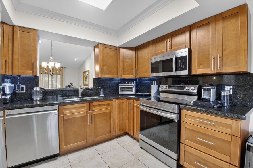 This BEAUTIFULLY RENOVATED, CORNER villa is located on a cul-de-sac street within walking distance to the active clubhouse! This superb home features a GORGEOUS KITCHEN with modern wood cabinets & hardware, granite countertops, stainless steel appliances, & an undermount stainless steel sink, as well as a spacious breakfast area & outdoor patio. The master bedroom suite features a large walk-in closet & RENOVATED bathroom with stall shower. The 2nd bath has also been updated. Lovely neutral color slip-resistant tile flooring compliments the home, along with A SKYLIGHT, and crown molding, new ceiling fans & lighting through-out. Enjoy the best of Florida living with a relaxing 20 foot long, glass and screen enclosed, AIR-CONDITIONED FLORIDA ROOM for year-round comfort!  This home boasts of a cost saving TANKLESS INSTANT HOT WATER HEATER, NEW 2022 ROOF, interior laundry, lush landscaping & 2 car parking right in front.  *Model was designed with space for an optional 3rd bedroom.*  This wonderful home has been gently occupied by snowbirds and is offered beautifully furnished.  This gated community features an active clubhouse, swimming pool, tennis courts, pickleball courts, sauna, fitness room, BBQ area, pier. Up to 2 pets welcome, up to 20 lbs each. HOA covers exterior paint, lawn, clubhouse, gate. Lovely West Boca area. Convenient to The Reserve Plaza, Delray Marketplace, shopping, dining, & major highways.
