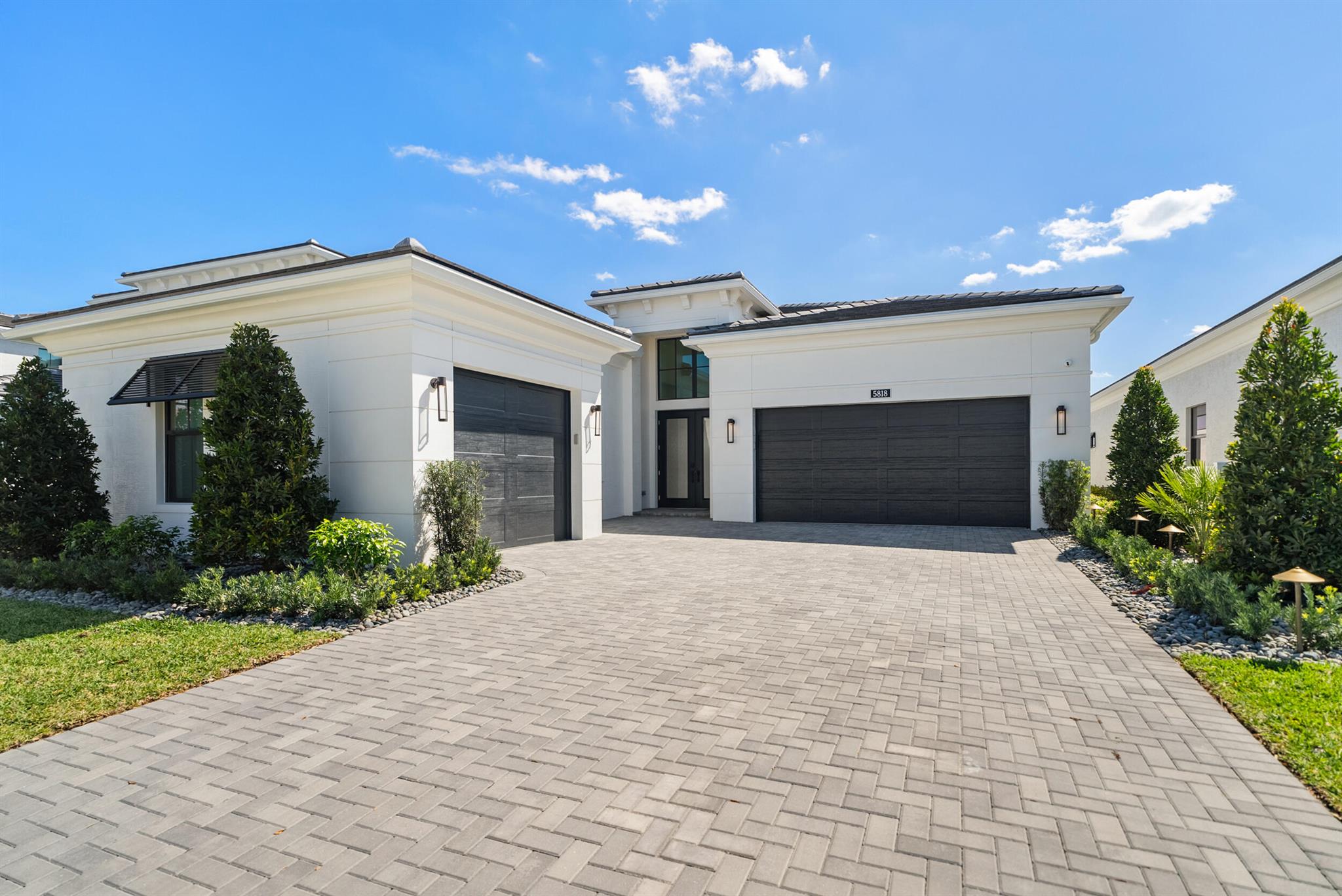 This stunning home is the largest single-story model in Artistry and is situated on a premium homesite with southern exposure and direct lake & fountain views! This impeccable home was just built and enhanced with over $500,000 of luxurious features! This 3 bedroom 3.1 bathroom home was designed to unwind and entertain. The swanky clubroom adds to the expansive space, and can also be a 4th bedroom. The gourmet kitchen features elevated cabinets, Monogram appliances with gas cooktop, 48'' refrigerator, quartz countertops & island with waterfall, and a dry bar complete w/ a wine cooler & ice maker. The primary bedroom & bathroom are a serene retreat with stylish lighting fixtures, a soaking tub, frameless shower, and a Toto bidet toilet. All closets are custom built by California Closets.