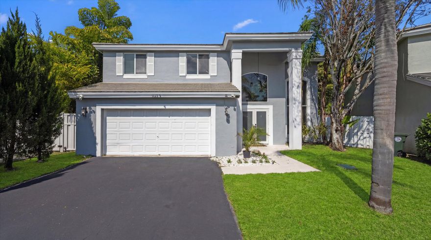 Welcome to this beautifully updated 3-bedroom, 2.5-bath home with a spacious loft, located in the desirable Laurens Turn community of Coconut Creek. This move-in-ready residence features soaring high and vaulted ceilings that fill the home with natural light and create an open, airy feel. The interior has been completely refreshed with brand-new laminate flooring throughout and a stunning, fully remodeled kitchen featuring new cabinetry and modern finishes. All bathrooms have been tastefully renovated, offering a clean, contemporary design. Enjoy peace of mind with major upgrades including brand new impact windows, a whole house Generac generator system, and a brand new hot water heater. The home has been freshly painted inside and out as well as epoxy garage flooring and new driveway blacktop. Step outside to a large fenced in back yard with extra property beyond the fence belonging to the home. The front and backyard have been completely re-sodded.  It offers privacy and room to entertain while looking out at the preserve and lake. This exceptional home combines modern upgrades, functional living space, and picturesque surroundings - a true must-see in Coconut Creek.