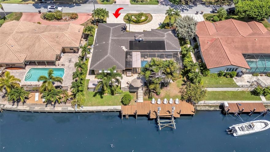 Welcome to your next home! Perfectly situated near Pompano Beach and Deerfield Beach, this elevated 2,291 sq. ft. residence offers a unique floor plan designed to flood the interior with natural light. Set on a generous 9,901 sq. ft. lot, the property features a circular driveway, tropical landscaping, and an oversized two-car garage with ample storage.Boating enthusiasts will appreciate 90-foot of water frontage on a deep-water canal with ocean access, accommodating multiple boats, including a vessel with T-tops. The fixed bridge offers a 9-foot clearance, ideal for various watercraft. Enjoy the best of Florida outdoor living with a large covered pool and patio area. This rare waterfront opportunity blends space, style, and lifestyle. Don’t miss your chance to own this exceptional home! The street is one of the most sought-after in the area—just minutes from top restaurants, shopping, the beach, and the Intracoastal Waterway. Whether you’re looking for a full-time residence or a vacation retreat, this Lighthouse Point gem checks all the boxes: space, light, water access, and unbeatable location.