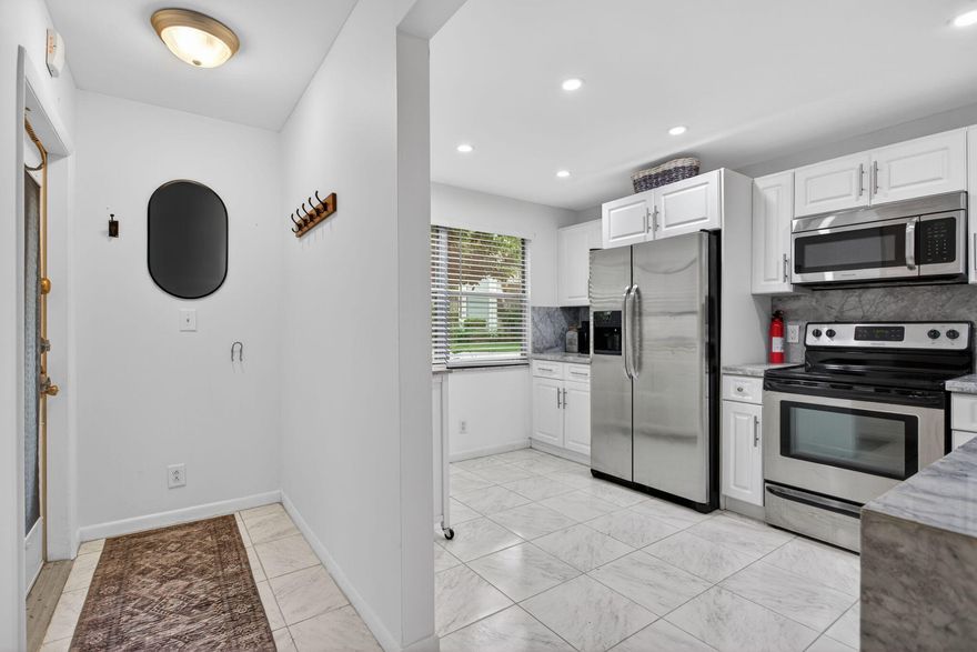 Beautiful corner unit, fully furnished, with a patio enclosure and a private door for an easy stroll to the village pool. Inside, you'll find an updated kitchen, refreshed ceilings, and alltile flooring throughout for a clean, cohesive look. Each bathroom includes its own window, bringing in natural light and added comfort. The A/C and water heater were both installed in 2013, offering peace of mind. Explore the photos and come experience it in person. The home is vacant—park in space #101 or in the Guest Parking area.