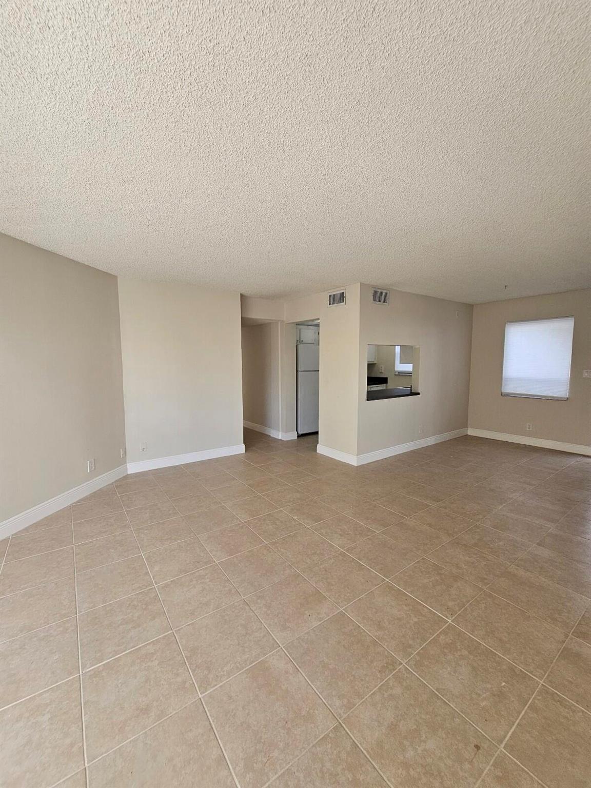 Discover comfort in this 1-bedroom, 1-bathroom 3rd-floor unit situated in the Presidential Golfview community. The building offers the convenience of an elevator, and the entire unit boasts stylish tile flooring. The kitchen comes equipped with newer appliances and features upgraded countertops. Enjoy easy access to Palm Beach Outlet, major roads, and downtown. Elevate your living experience in this well-appointed unit