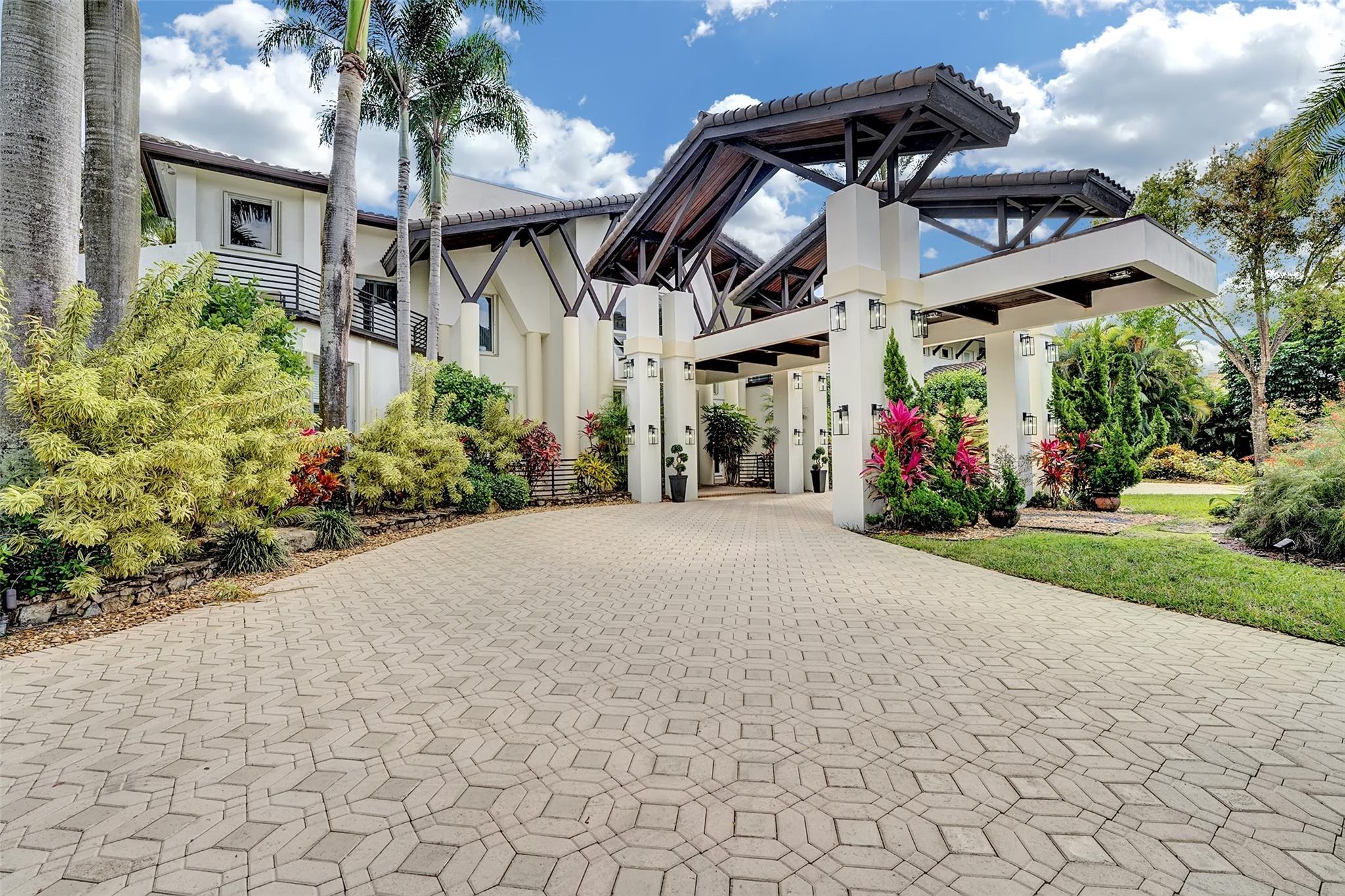 Magnificent mixture of mid-century modern and contemporary architectural masterpiece, 11,794 total square feet on 2.2 acres of private gated compound. Walk in the foyer to dramatic 30 foot ceilings and a 600 gallon jellyfish tank. Hi-end stainless steel appliances, gourmet kitchen, granite countertops, hardwood & marble floors throughout the living area! Large den, office & recreation room. Very nice in-law quarters completely separate from the main house with a full kitchen. The main attraction is the 140,000 gallon swimming pool, jacuzzi with waterfalls with a fire feature, & a swim-up bar. Large windows everywhere, sun filled in every room. Private patios w/ views of pool, land, basketball court, and much more. If you love to entertain this is the home for it, it is your own resort!