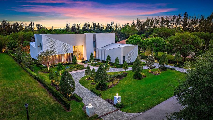 Welcome to this one-of-a-kind modern sanctuary in the heart of Palm Beach Gardens, an ultra-luxury architectural triumph that marries innovation, sophistication and serene beauty!  Spanning 11,144 square feet of living space, this bespoke residence encompasses  five bedrooms, eight bathrooms and two half baths all set against the tranquil backdrop of Japanese-inspired gardens. Meticulously constructed under the direct supervision of the owner, every element reflects the highest standards of modern design and engineering where no detail has been overlooked.