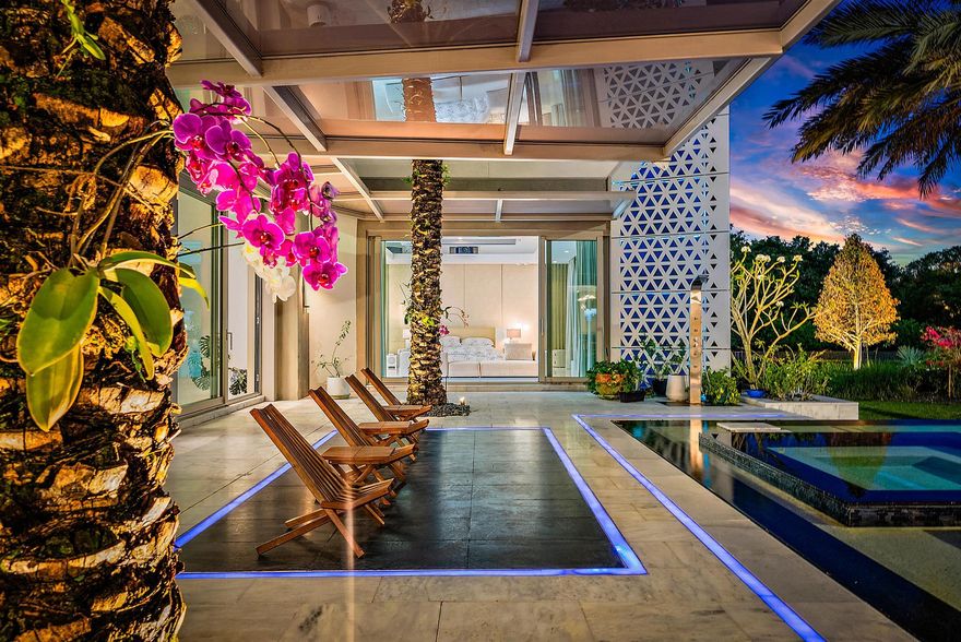 Welcome to this one-of-a-kind modern sanctuary in the heart of Palm Beach Gardens, an ultra-luxury architectural triumph that marries innovation, sophistication and serene beauty!  Spanning 11,144 square feet of living space, this bespoke residence encompasses  five bedrooms, eight bathrooms and two half baths all set against the tranquil backdrop of Japanese-inspired gardens. Meticulously constructed under the direct supervision of the owner, every element reflects the highest standards of modern design and engineering where no detail has been overlooked. Introducing this magnificent residence, the impressive two-story vestibule sets the tone for what lies within, showcasing a glass-suspended staircase, glass-enclosed commercial elevator adorned with an artistic mural finish, and a floor-to-ceiling glass facade that frames views of the exquisitely landscaped front yard. The grand living room is bathed in natural light, crowned by a soaring 25-foot ceiling,  and anchored by a sleek ribbon fireplace set against blue lacquered panels that cleverly conceal media. 10 foot sliding glass doors open to reveal a tranquil oasis with lush gardens and a sun-splashed 75 foot lap pool with spa.

Epitomizing elegance,  the adjoining dining room is equally inviting, with a tray ceiling and serene pool vistas.  For more informal living, the family room flows seamlessly with the kitchen, finished with professional-grade appliances, an expansive butler's pantry, and handsome custom cabinetry with tons of storage that integrates a work island and a floating breakfast bar extension. 

The first-floor primary suite is a peaceful haven, with two walls of glass that open to the pool and gardens. This luxurious retreat comprises his and hers custom-fitted wardrobe closets and dual spa-inspired bathrooms, finished in full marble slabs and fitted with steam showers and Toto bidet toilets. 

Perfectly suited for grand entertaining and everyday indulgence are an indoor/outdoor loggia with summer kitchen, a  fully-equipped gym, two guest suites, library and four-car garage on the first level. Upstairs,  a nine-seat custom theatre and two additional bedroom suites are complemented by a lounge and kitchenette offering comfort and privacy for guests. Additional features throughout include 10 foot ceilings and doors throughout, stainless steel panelized framing, insulated/laminated impact windows throughout, automized shades,  imported rain showers in the bathrooms, flush Italian doors, Smart House/Savant system, whole-house generator with propane tanks, eight-zone air conditioning, and instant hot water heaters. 

DISCLAIMER: Information published or otherwise provided by the listing company and its representatives including but not limited to prices, measurements, square footages, lot sizes, calculations, statistics, and videos are deemed reliable but are not guaranteed and are subject to errors, omissions or changes without notice. All such information should be independently verified by any prospective purchaser or seller. Parties should perform their own due diligence to verify such information prior to a sale or listing. Listing company expressly disclaims any warranty or representation regarding such information. Prices published are either list price, sold price, and/or last asking price. The listing company participates in the Multiple Listing Service and IDX. The properties published as listed and sold are not necessarily exclusive to listing company and may be listed or have sold with other members of the Multiple Listing Service. Transactions where listing company represented both buyers and sellers are calculated as two sales. "No payments made until title passes" Some affiliations may not be applicable to certain geographic areas. If your property is currently listed with another broker, please disregard any solicitation for services. Information published or otherwise provided by seller, listing company or its representatives is deemed reliable but are not guaranteed and subject to errors, omissions, or changes without notice. Copyright 2026 by the listing company. All Rights Reserved.