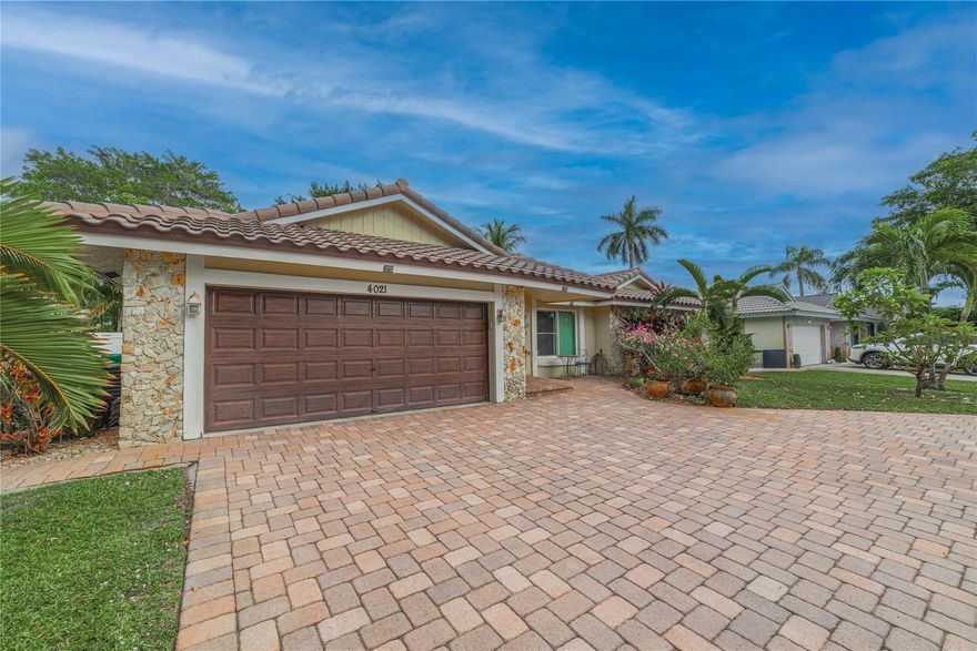 Welcome to this stunning 3/2 home in sought out Coral Springs! Boasting incredible curb appeal, circular paver driveway & double-car garage. Inside discover open & airy luxurious living spaces with soaring high ceilings & tile throughout. Kitchen features SS appliances, breakfast area & plenty of counter space. Rest easy knowing your home is fully equipped with impact windows & doors, & new roof installed in 2016. The main suite is a serene retreat with a walk-in closet & double glass doors leading to a peaceful back patio surrounded by lush landscape. The spa-like bathroom features a custom vanity & a shower with water pressure jets. Guests can enjoy 2 spacious bedrooms & beautifully designed bathroom complete with double vanities. HOA FEE ONLY $473.56 PER YEAR!! Schedule a showing today!
