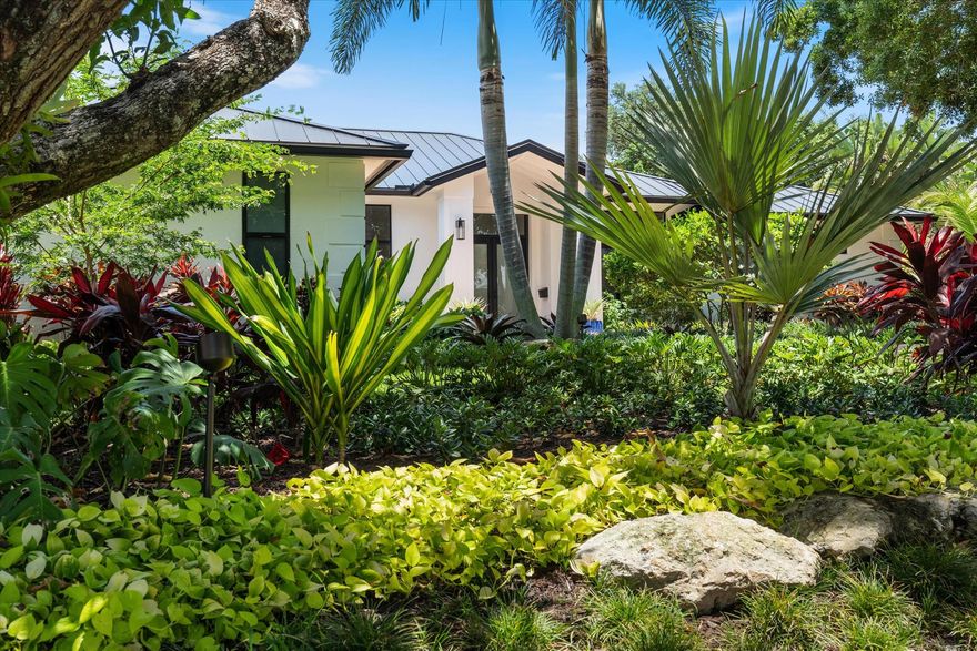 Introducing a beautifully renovated single-story home at Lake Ida, featuring  a .35 acre lot 15,476 ft., a putting green, a citrus grove, 5 bedrooms and 3 baths, set back for added privacy and surrounded by stunning trees. This home boasts a brand-new black metal roof and hurricane impact windows and doors.The open-concept family and living areas are perfect for gatherings, while the fully updated contemporary bathrooms include a convenient cabana bath. The modern white shaker-style kitchen, equipped with a pantry and quartz countertops, makes entertaining a breeze. The fifth bedroom serves as an office or den.Step outside to the lanai, ideal for alfresco dining and entertaining, overlooking a spacious 15 x 30 ft saltwater pool. Nestled on one of the most sought-after streets.