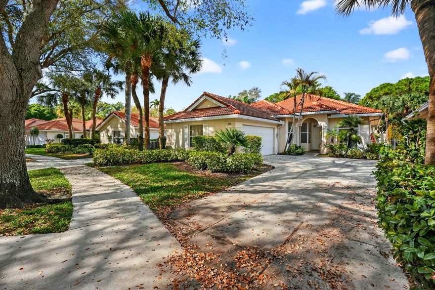 Welcome to the heart of Palm Beach Gardens! This one-of-a-kind home is located in a prestigious manned gated community known for its majestic oak-lined streets, lush landscaping, and peaceful atmosphere. The standout feature is the stunning main living area with dramatic soaring ceilings. The beams and trusses are wrapped in a light wood finish, creating a warm architectural look while concealing ductwork for a clean, elegant design. The ceiling rises all the way to the roofline, giving the space a bright, open feel. The home also features a newer roof and AC and private pool with new pump and filter. Residents enjoy resort-style amenities  located just minutes from world-class dining, golf and TGL SOFI stadium, shopping, marinas, and beaches! Showings to start Saturday 3/14 12-3PM, call LA for gate access.