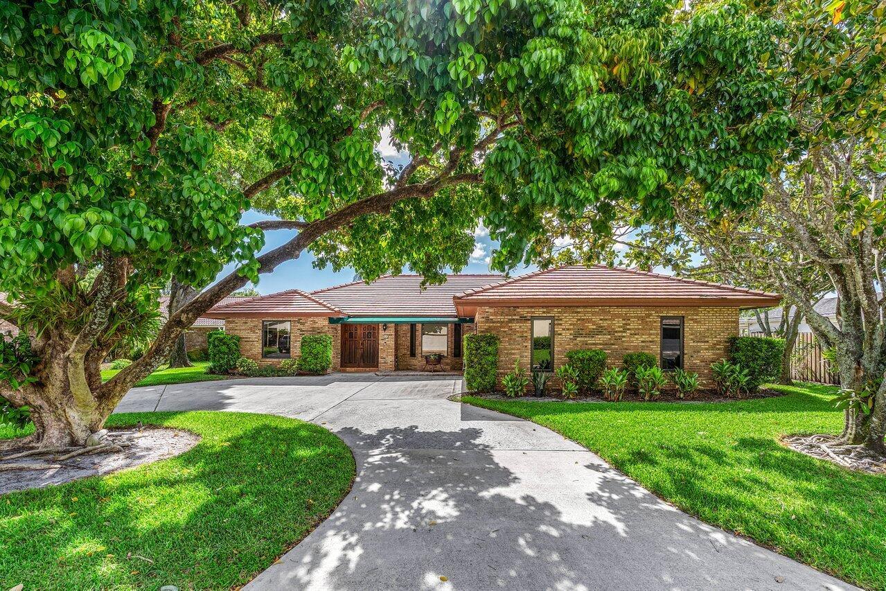Tucked away on a quiet cul-de-sac in the highly sought-after Pines at Boca Del Mar, this charming 3-bedroom, 2-bathroom single-story brick home offers the perfect blend of comfort, character, and convenience. Set on an expansive 1/4-acre fenced lot, this home delivers privacy and tranquility, with direct backyard access to Pinewood Park - perfect for morning walks, lake views, or playtime with the family. Step inside and be welcomed by a bright bay window sitting area, cozy fireplace, and a thoughtful split floor plan offering nearly 2,000 square feet of living space. The kitchen boasts two large pantries, stainless steel appliances, a wine rack, ample cabinet space, and a freestanding island ideal for entertaining or everyday living.