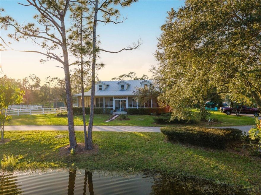 Beautiful 14.2 acre equestrian training facility in Palm City. This tranquil property features 3 barns with a total of 14 stalls, a covered arena, round pen and multiple grassy paddocks for turnout. There is also a lovely 2 bedroom 2 bath owner's or manager's house with wrap around porch. The main barn is complete with a tack room, feed room, wash rack, grooms quarters or riders lounge and plenty of storage space or room for additional stalls. There is a separate storage building for tractors and farm machinery. With a beautiful pond and plenty of space, this facility offers a truly idyllic setting for all of your equestrian needs.