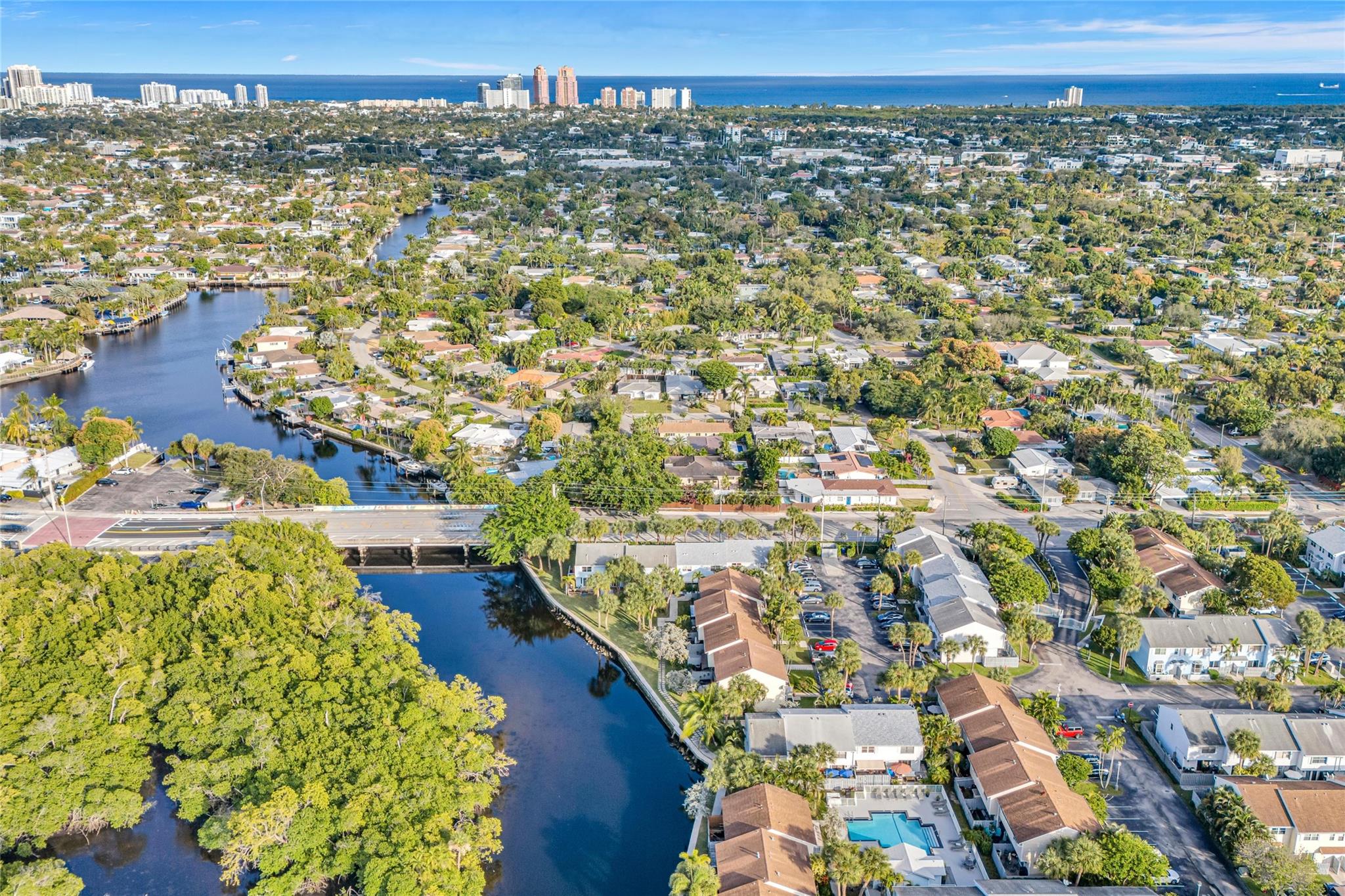 Discover unparalleled luxury at Edgewater Townhomes! This exquisitely renovated, fully furnished 2-story residence in East Fort Lauderdale offers a magazine-design home aesthetic. High-end finishes abound, from the gourmet kitchen with top-tier appliances and quartz counters to sun-drenched, open-concept spaces with wood-look flooring. Retreat to serene bedrooms; the upstairs bath is a spa-like oasis with dual vanities, a luxurious walk-in shower and a soaking tub. Newly paved patio boasts an electric awning and serene canal views. Enjoy canal views from the primary bedroom! Nestled in a rare gated community with a sparkling pool. Moments from Las Olas, Wilton Manors, vibrant dining, shopping, and pristine beaches. This move-in ready home epitomizes South Florida convenience and style!