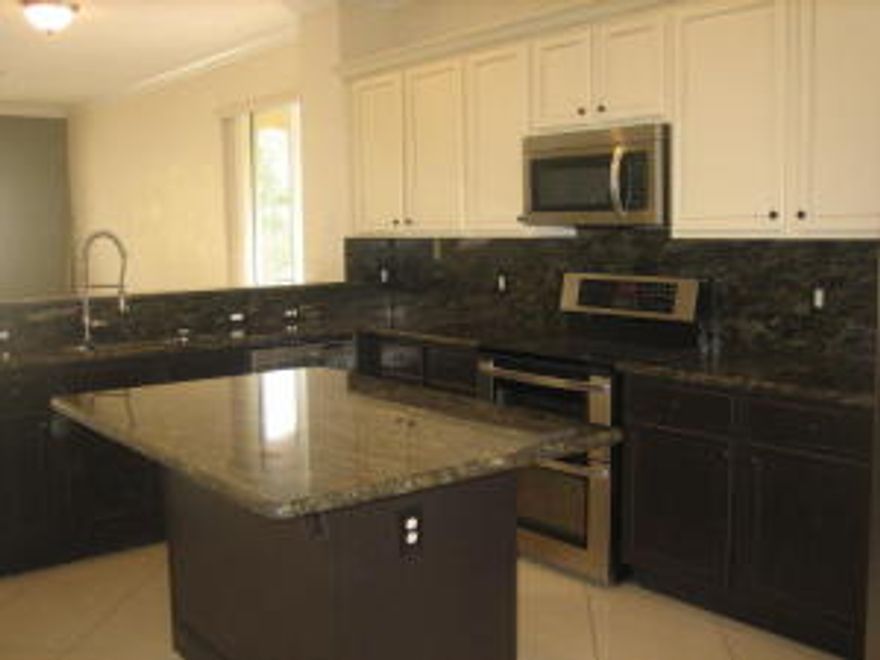 Spacious 3 bedroom plus den corner town home with 2 car garage in the heart of Boynton Beach! Renovated kitchen with granite counter tops, center island, and stainless steel appliances. Tile on the diagonal throughout living areas, newer berber carpet, convenient upstairs laundry, and neutral color palette. Light and bright! Den makes convenient office or 4th bedroom. Park like community features pool, exercise room, picnic area, playground, and basketball. Minutes away from shopping, restaurants, and I-95.